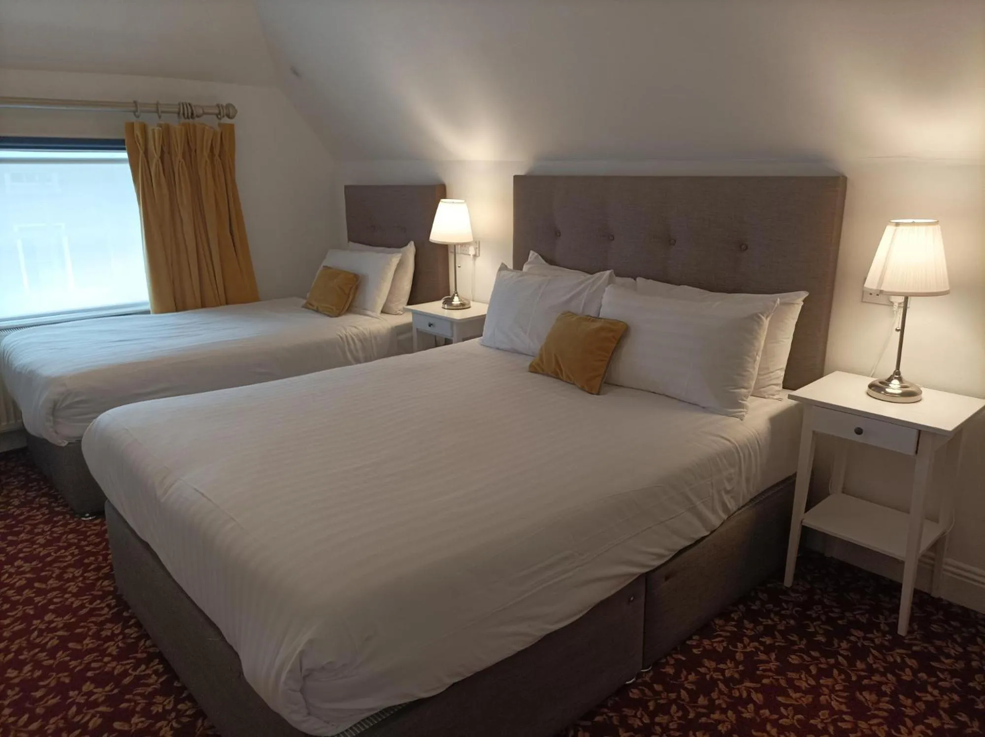 Bed in Tom Dick and Harriet's Accommodation