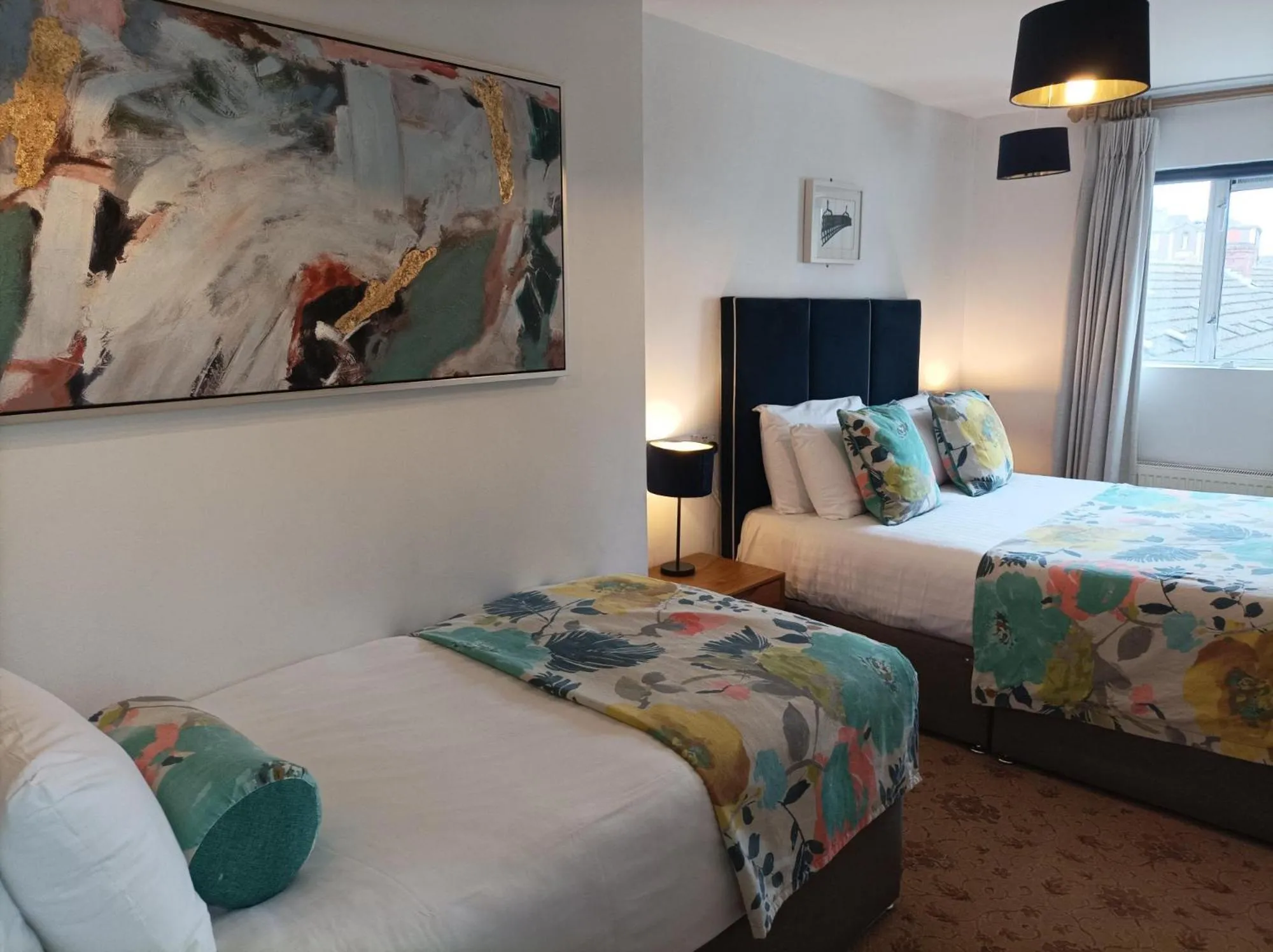 Bed in Tom Dick and Harriet's Accommodation