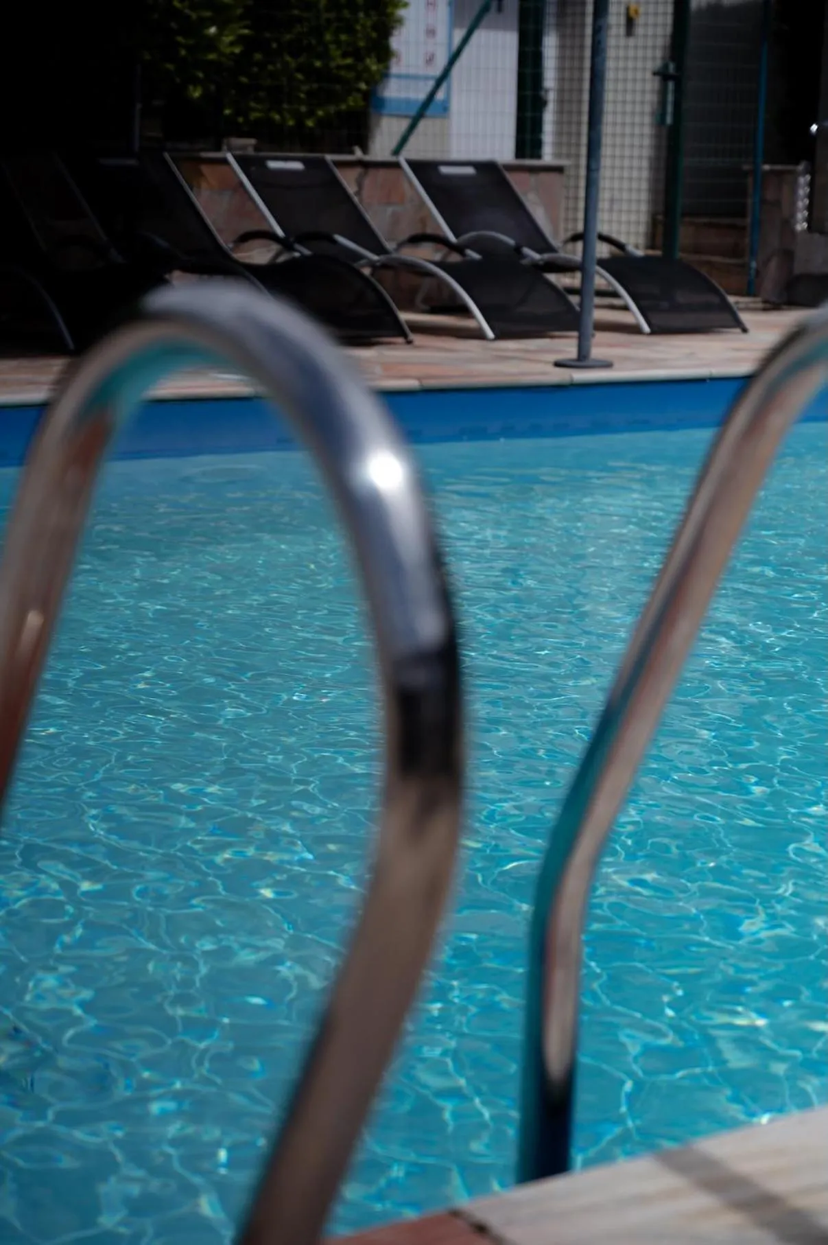 Swimming pool in Logis Hôtel Le Bellevue