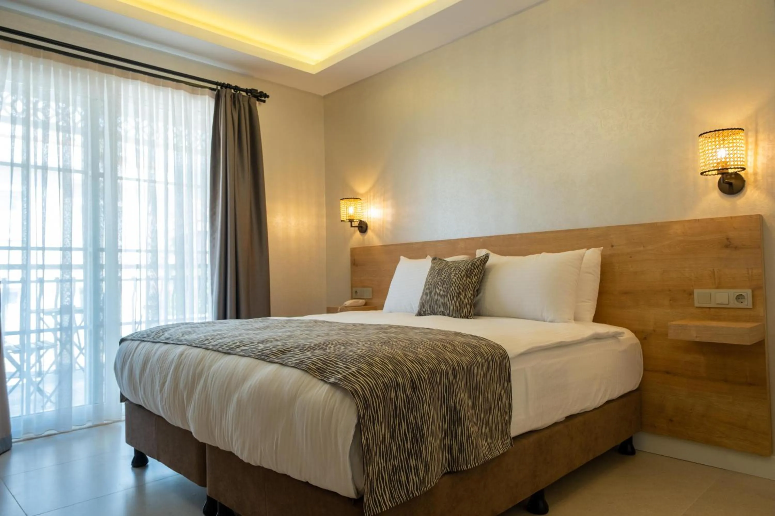 Bed in Sea Breeze Hotel and Apartments