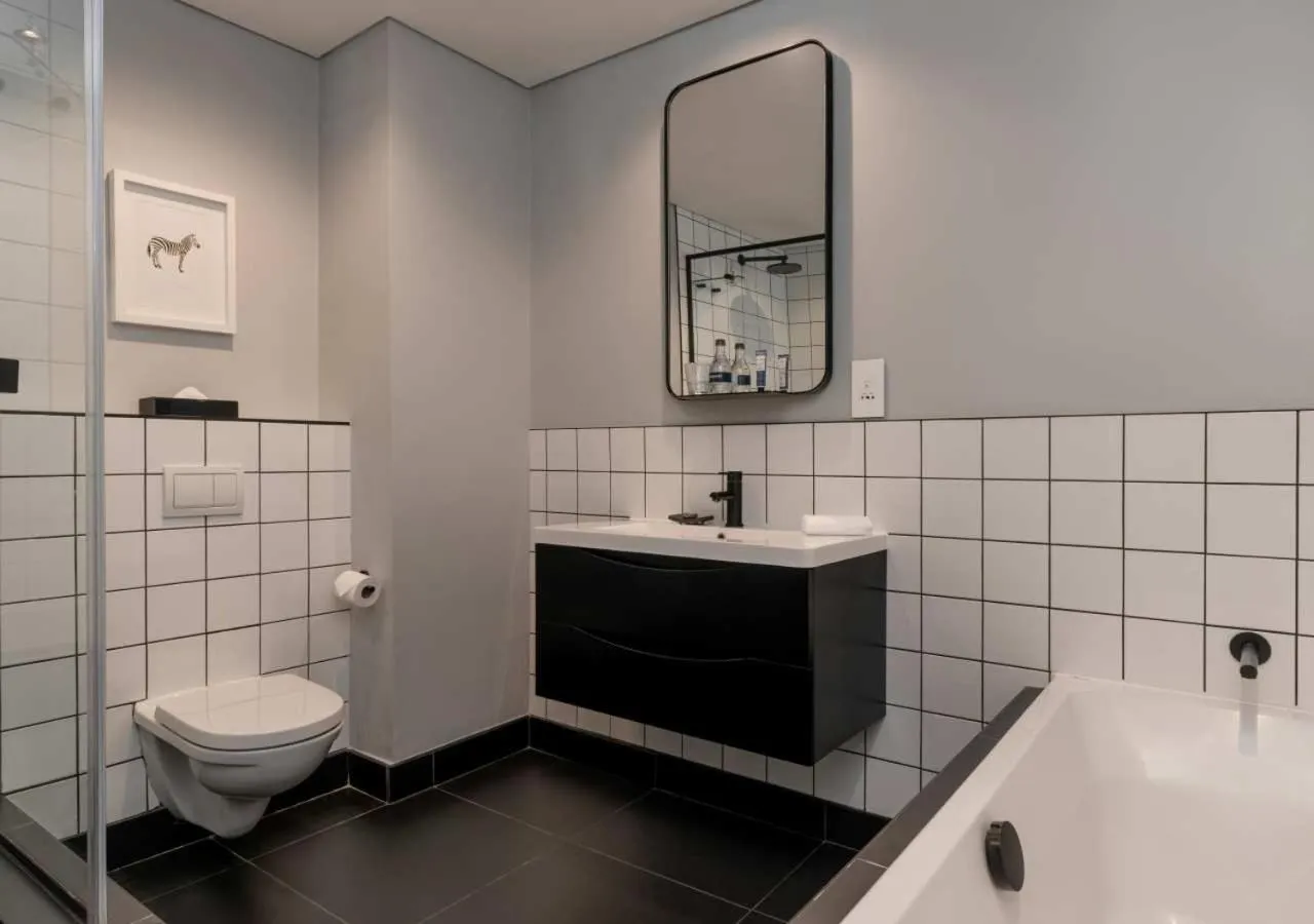 Shower in The Onyx Apartment Hotel by NEWMARK