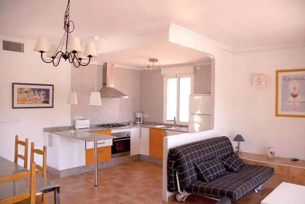 Kitchen or kitchenette in Apartamentos Oasis de las Palmeras
