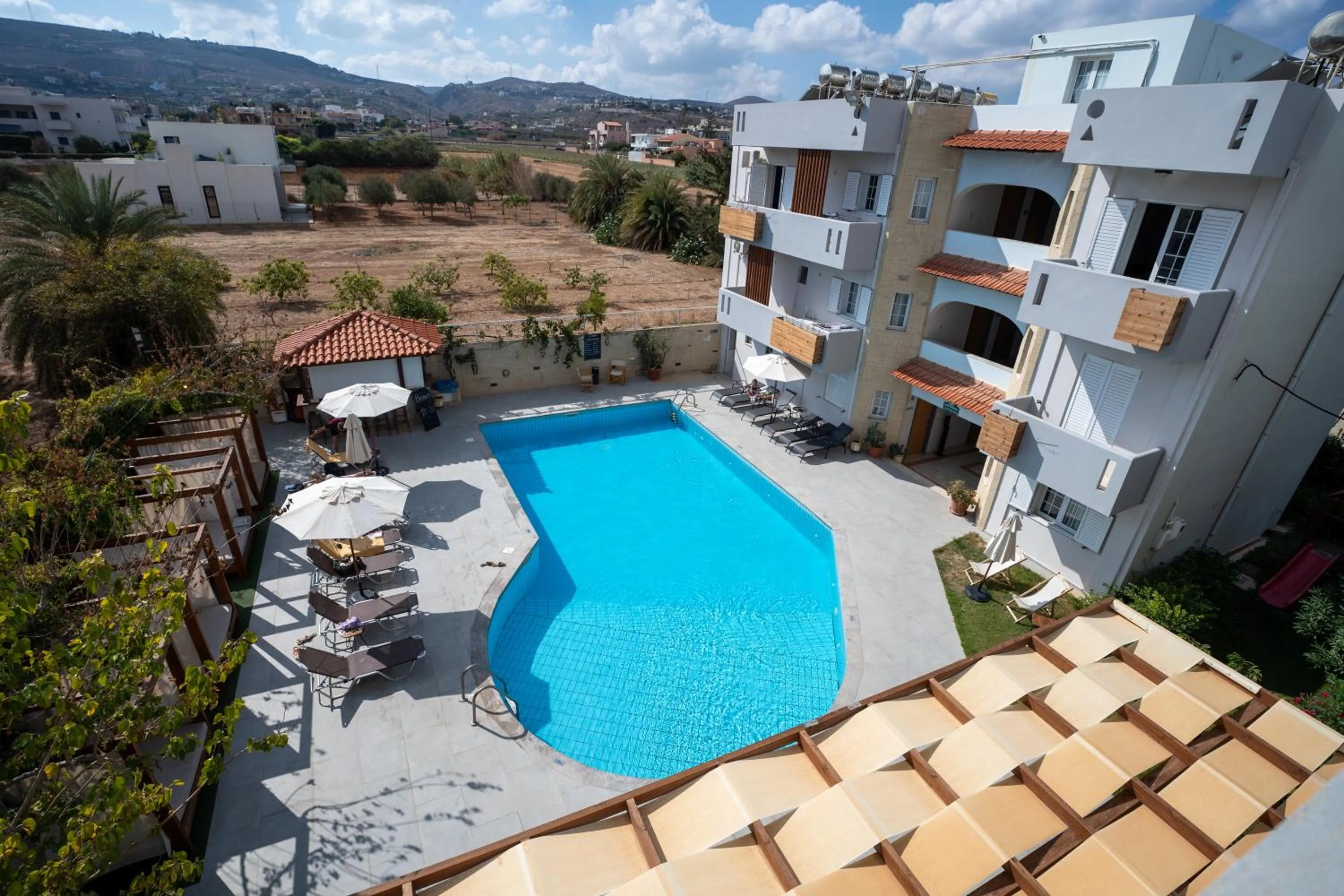 Swimming pool in Dimitra Hotel & Apartments by Omilos Hotels