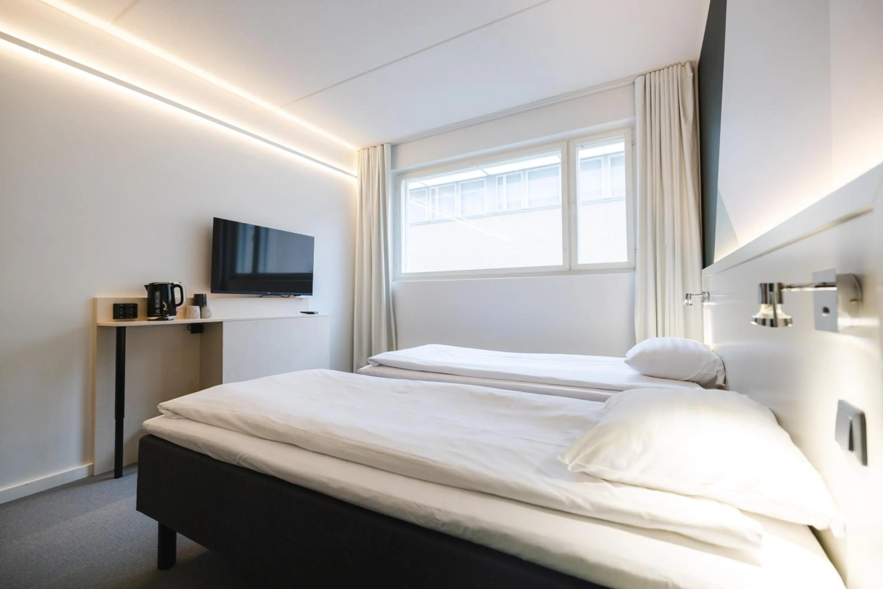 TV and multimedia, Bed in GreenStar Hotel Joensuu