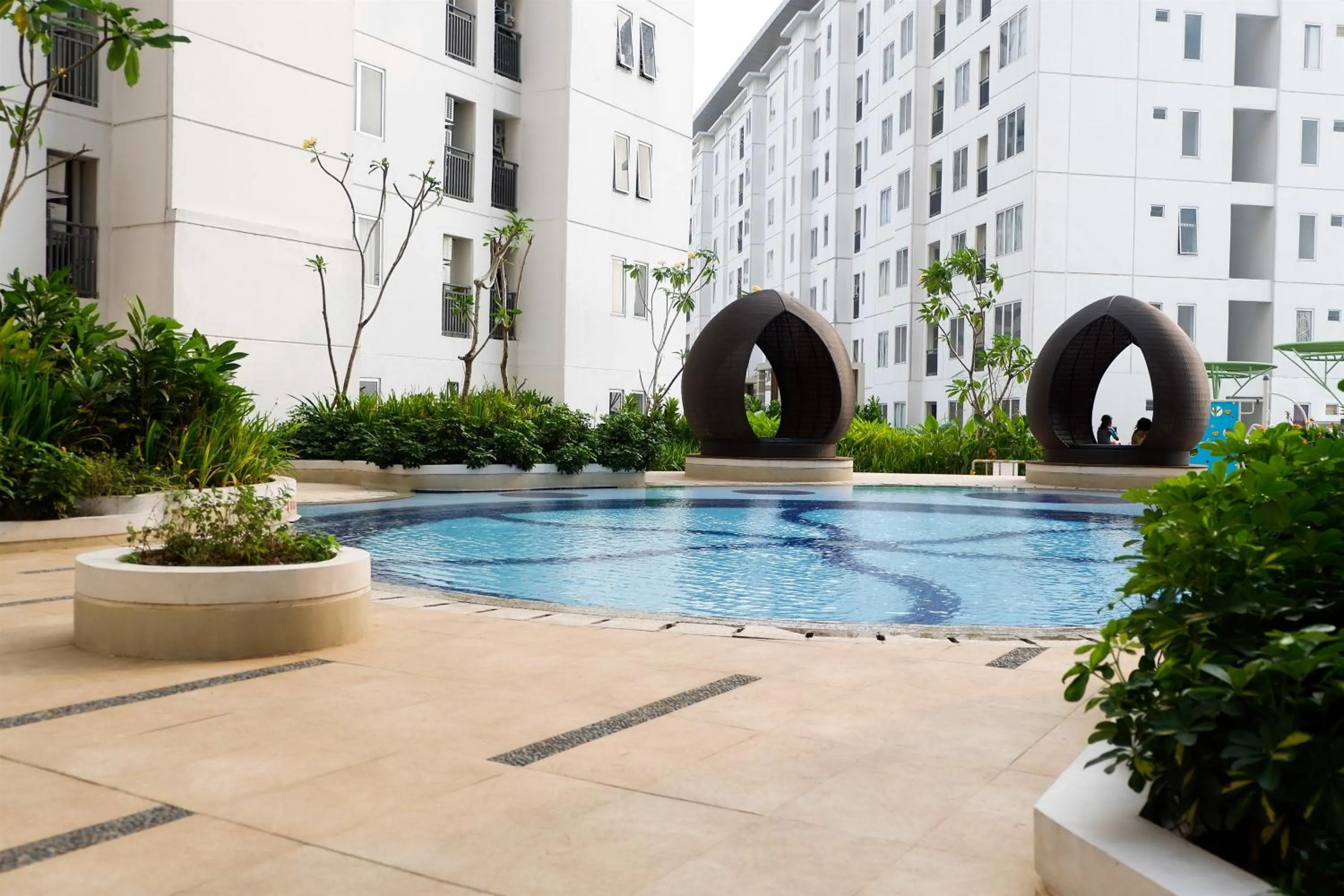 Swimming pool in Modern Studio Bassura City Apartment By Travelio
