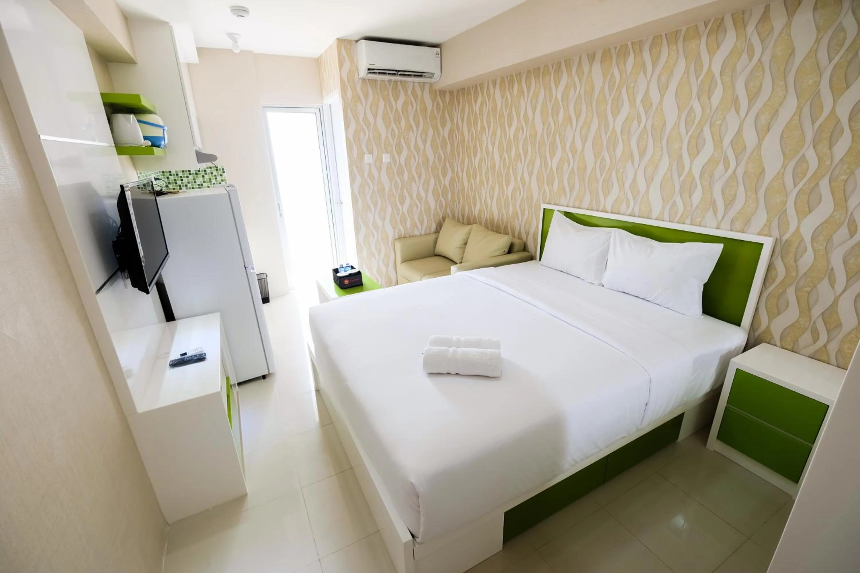 Bedroom, Bed in Modern Studio Bassura City Apartment By Travelio