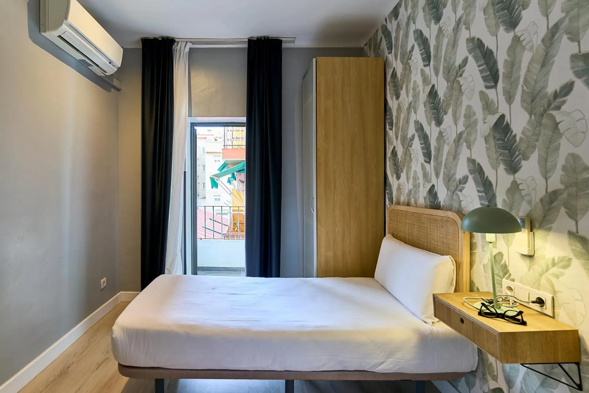 Bed in Fira Apartments by gaiarooms