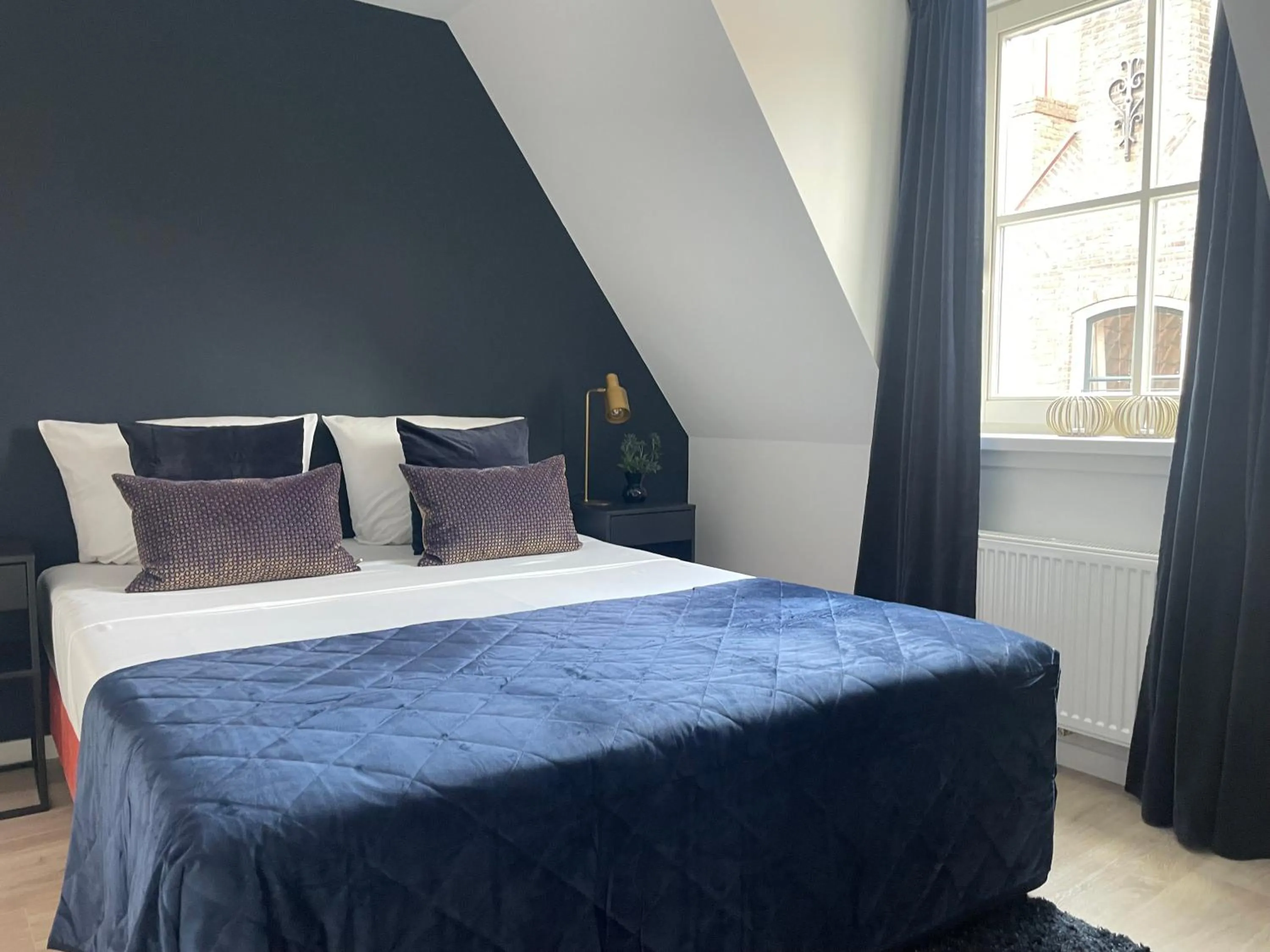 Bed in The Roosevelt Apartments