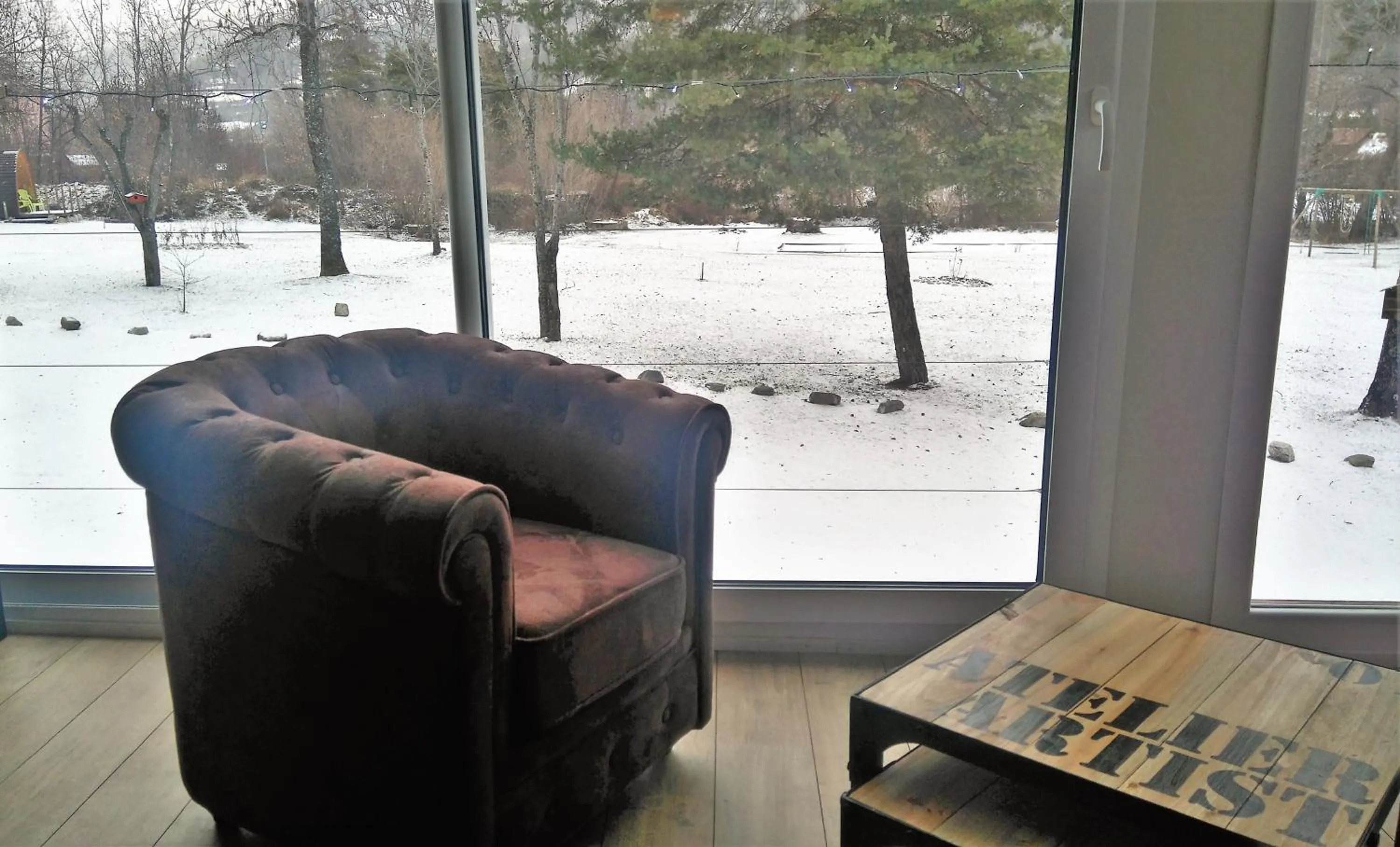 Communal lounge/ TV room in Hôtel Le Martagon