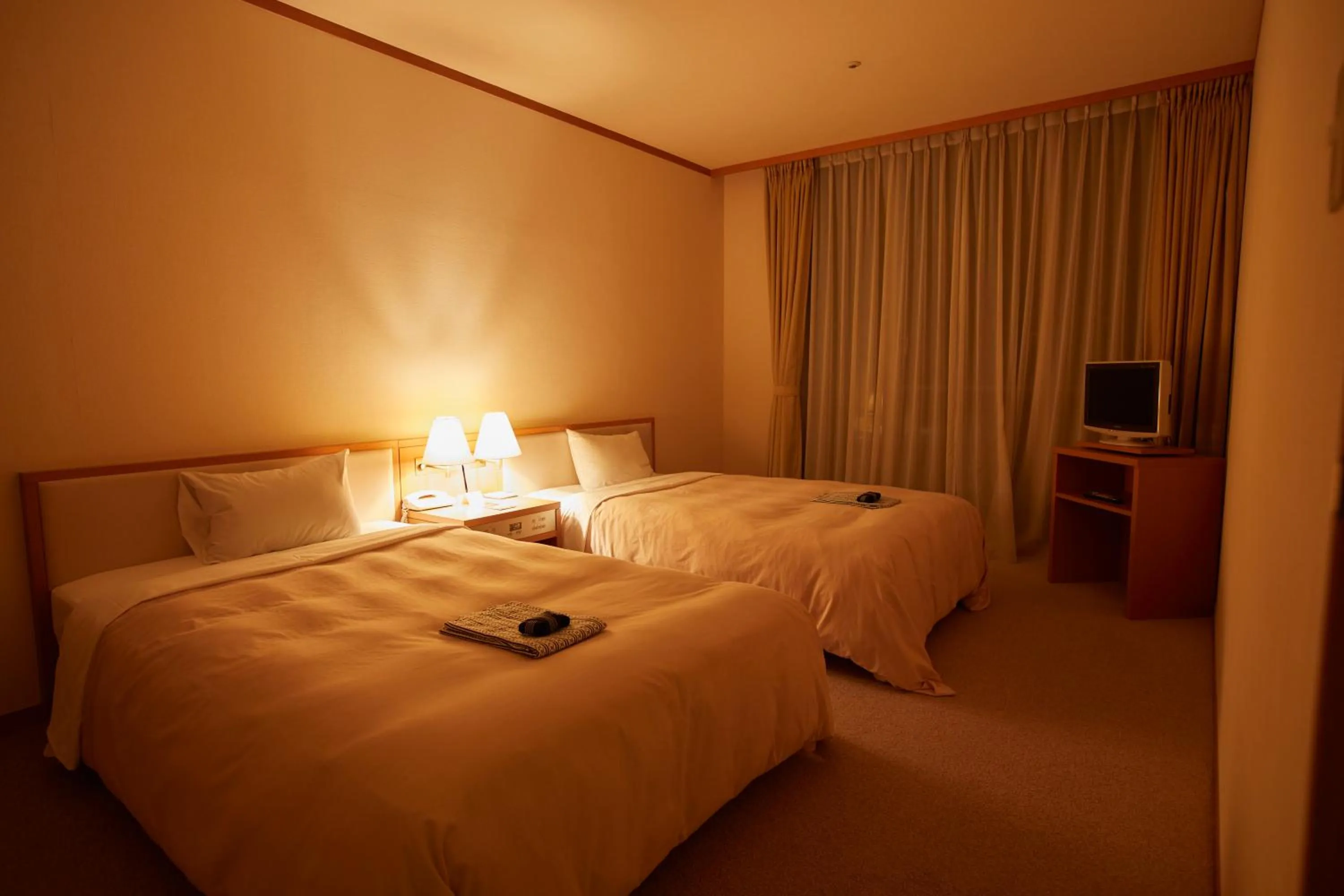 Bed in Kamogawa Country Hotel