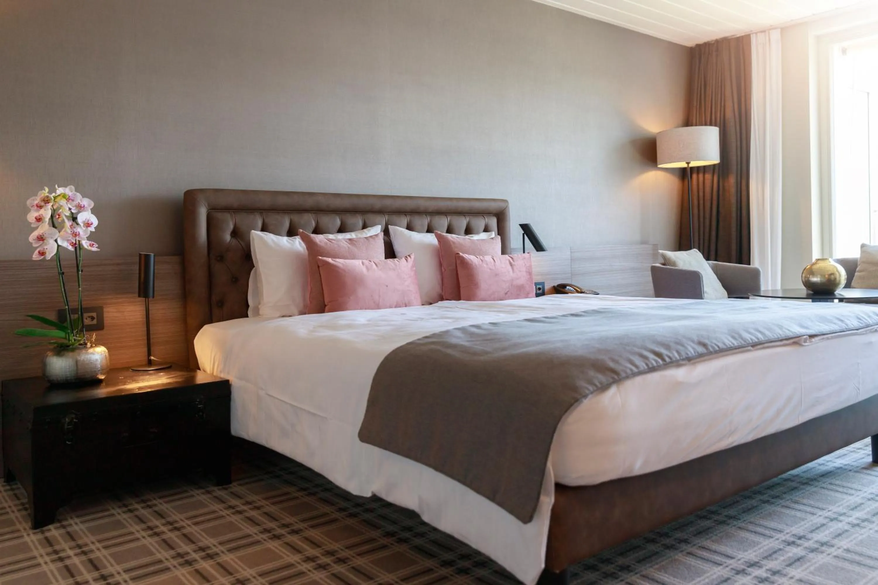 Bed in Ambassador Boutique Hotel