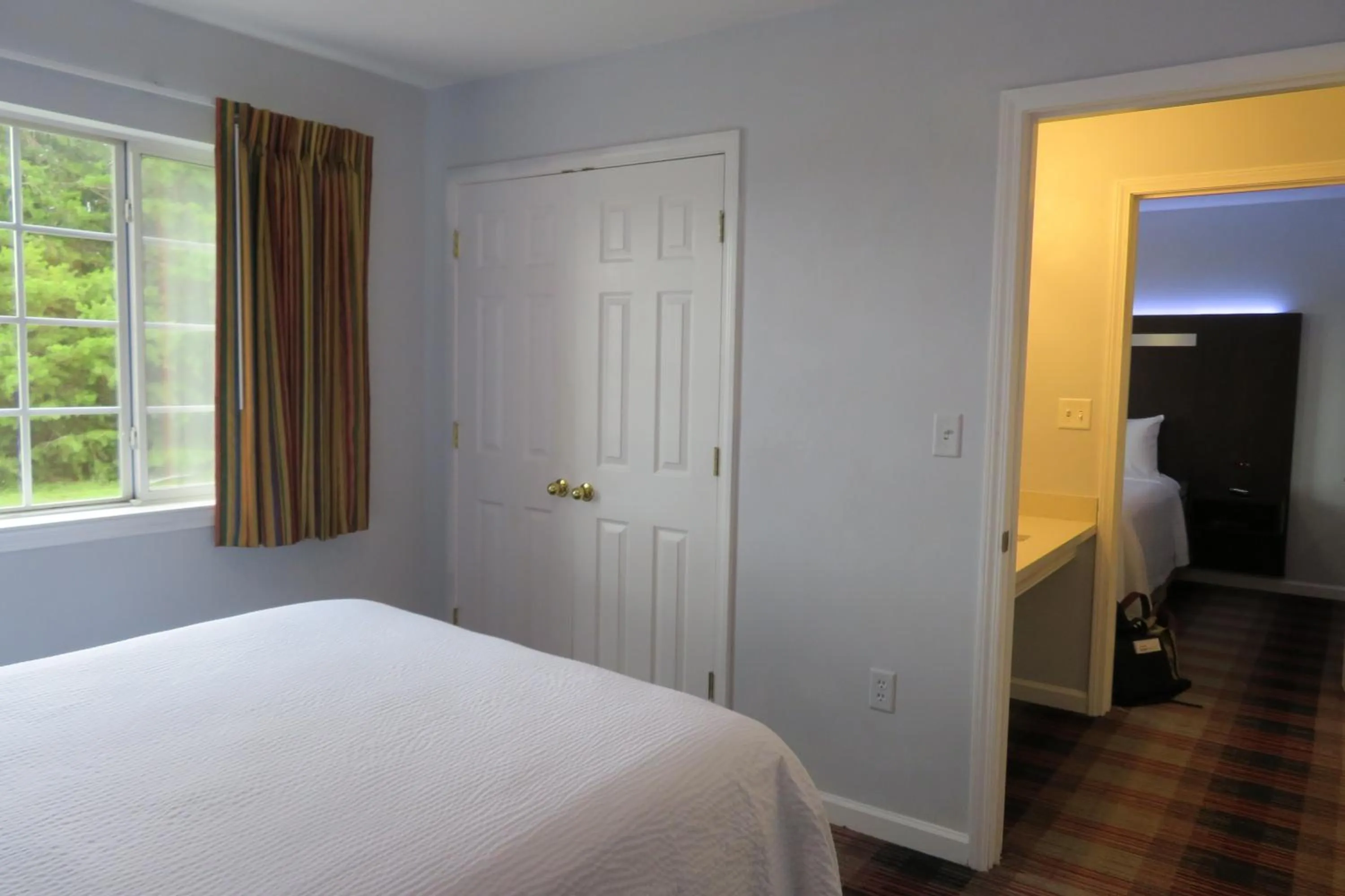 Bed in Luxbury Inn & Suites