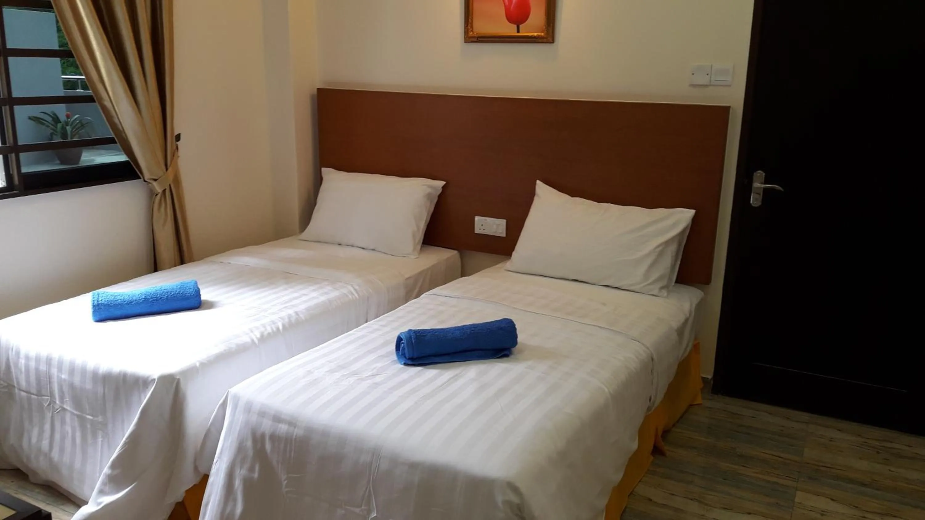 Bed in TULIP HOTEL & APARTMENT