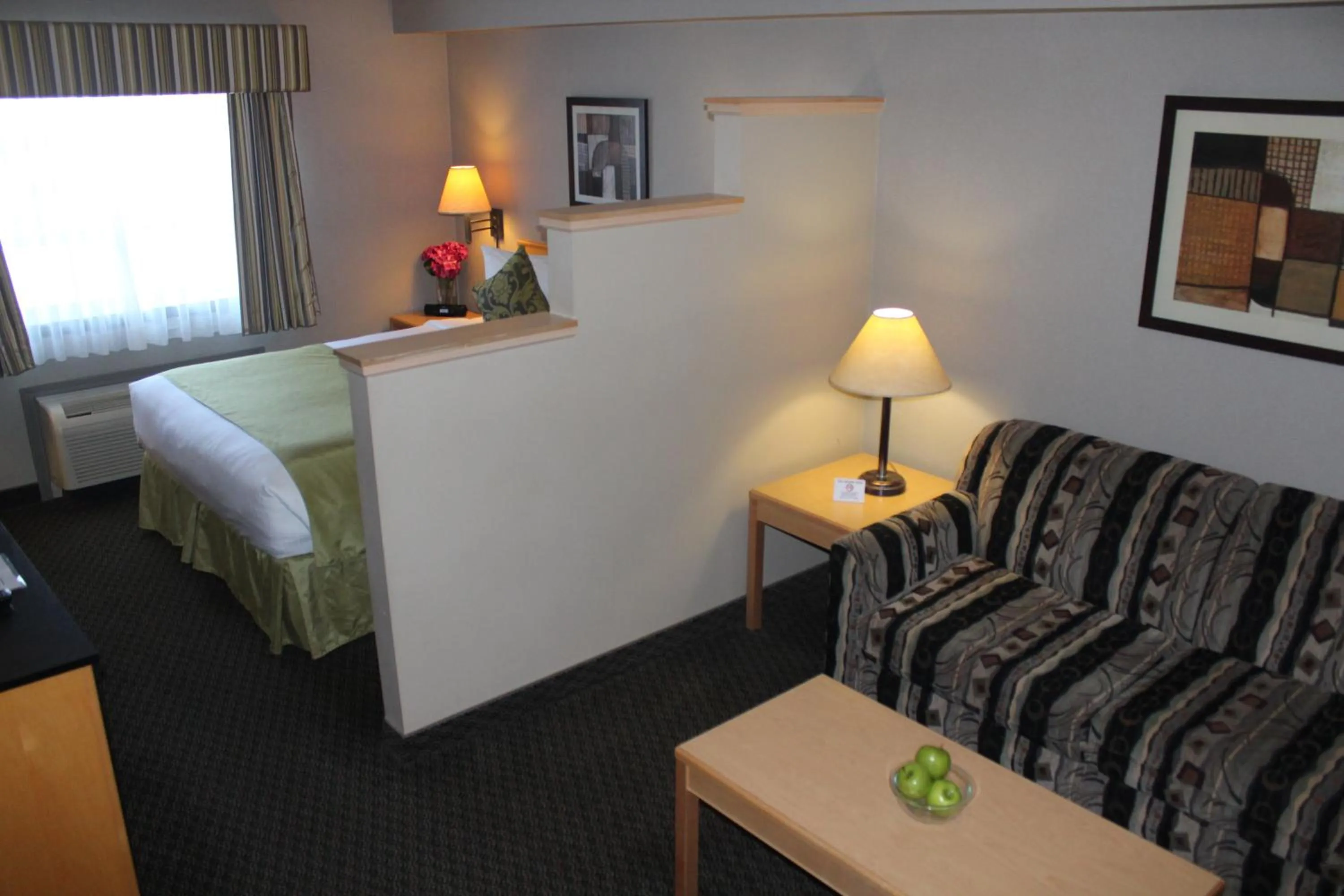 Seating area, Bed in Travelodge by Wyndham Fort McMurray