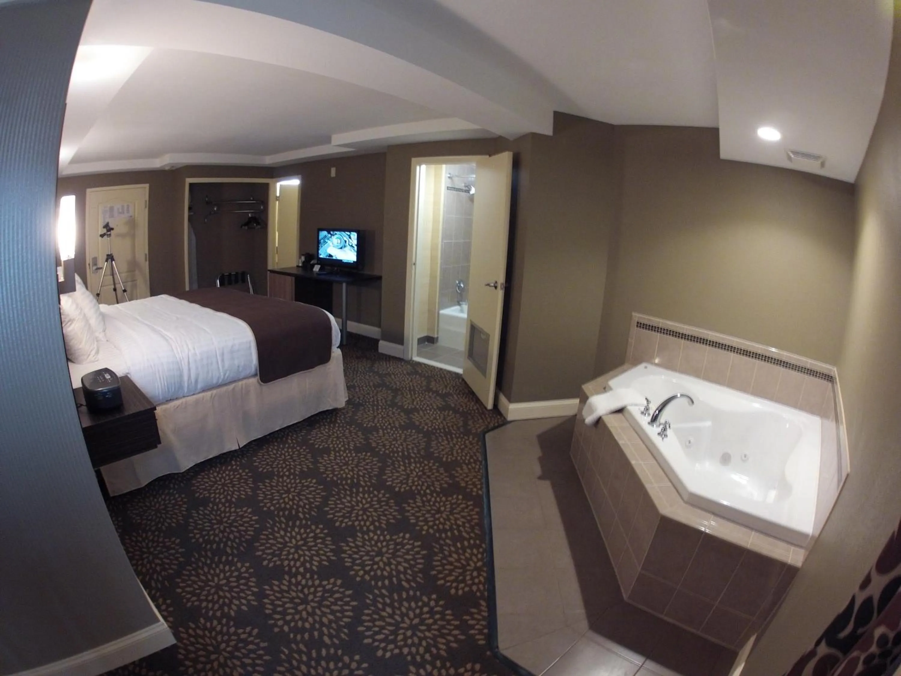 Photo of the whole room, Bed in Aashram Hotel by Niagara River