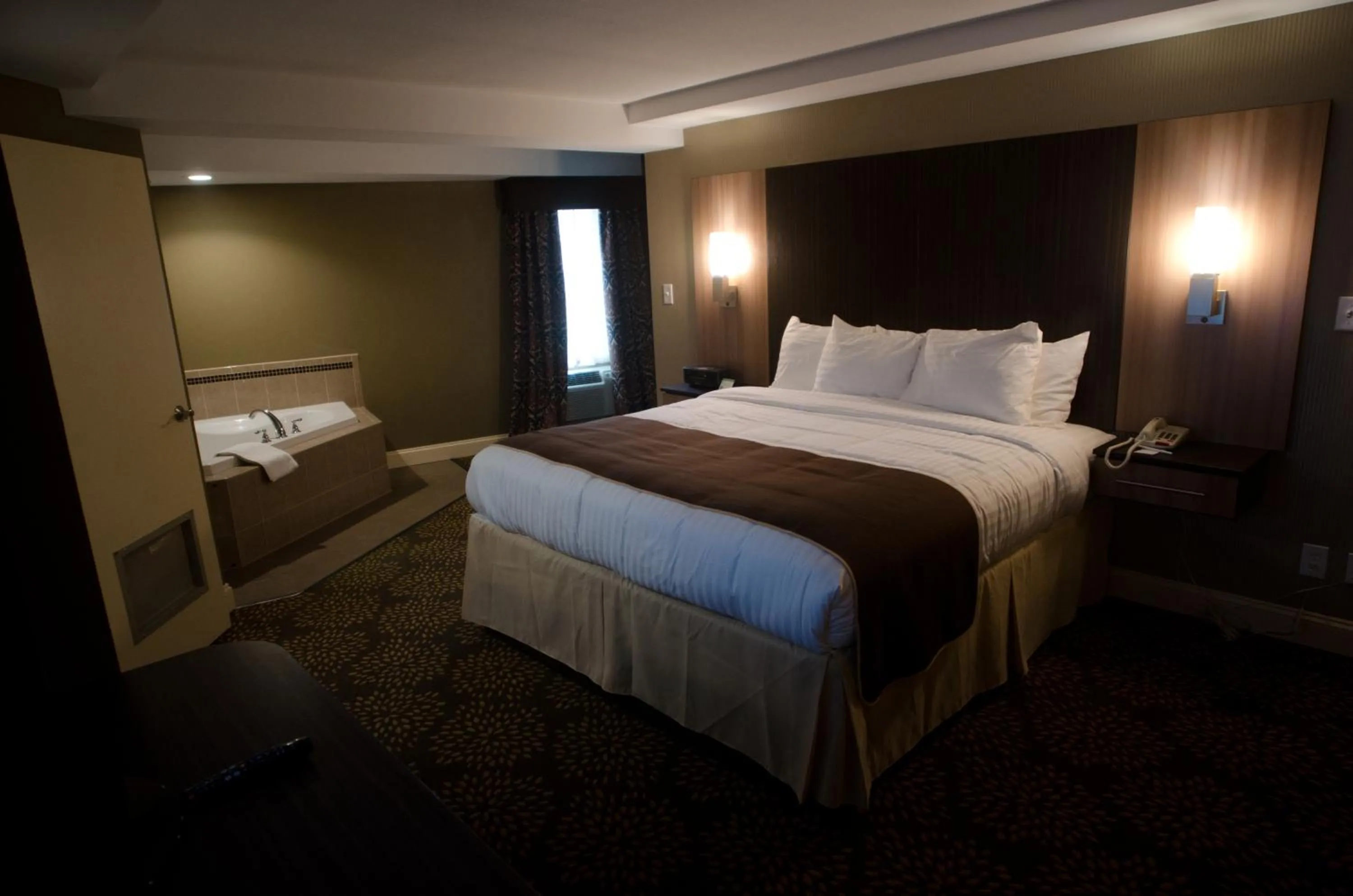 Photo of the whole room, Bed in Aashram Hotel by Niagara River