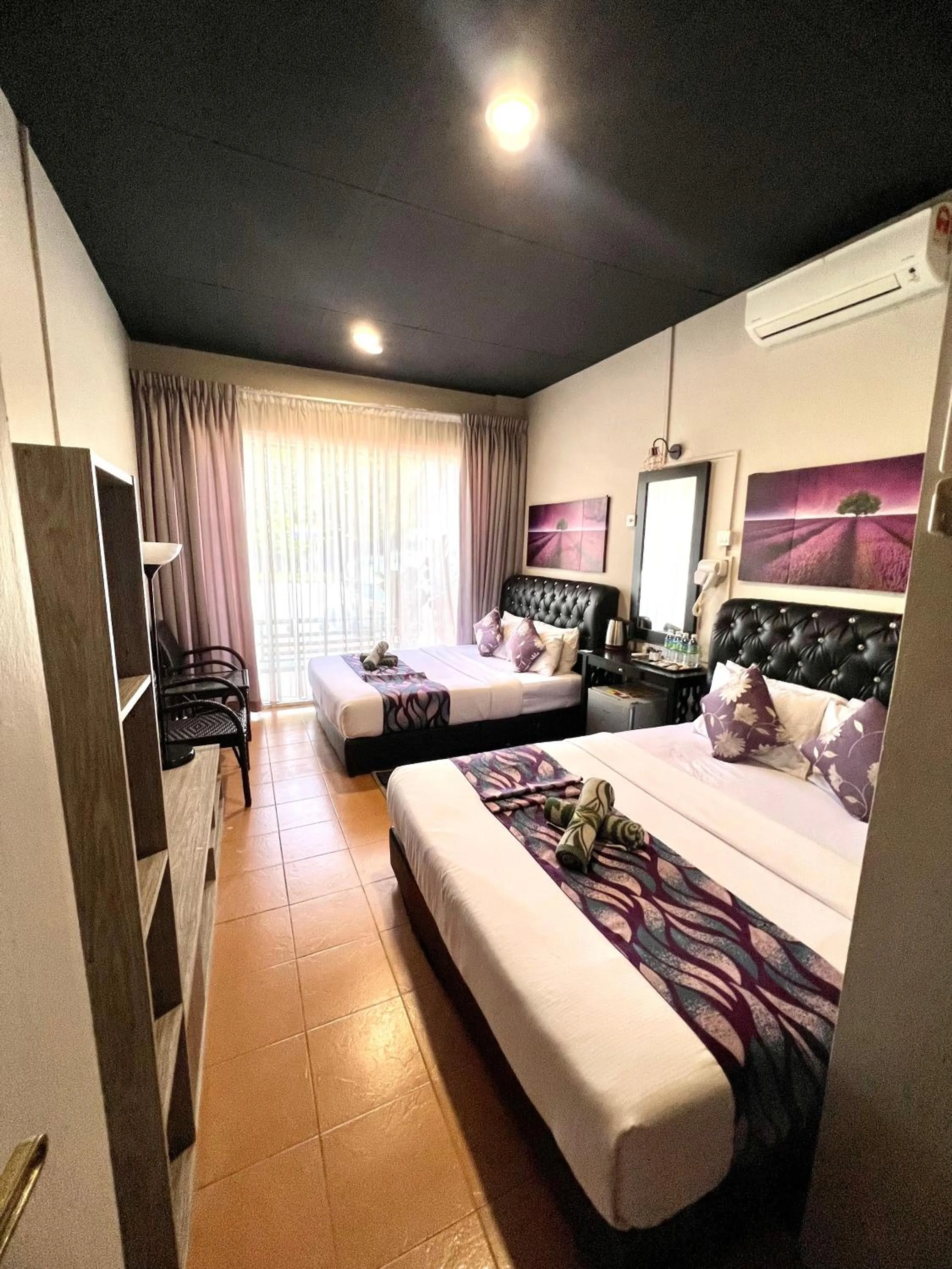 Bed in Ghazrin's Garuda Hotel