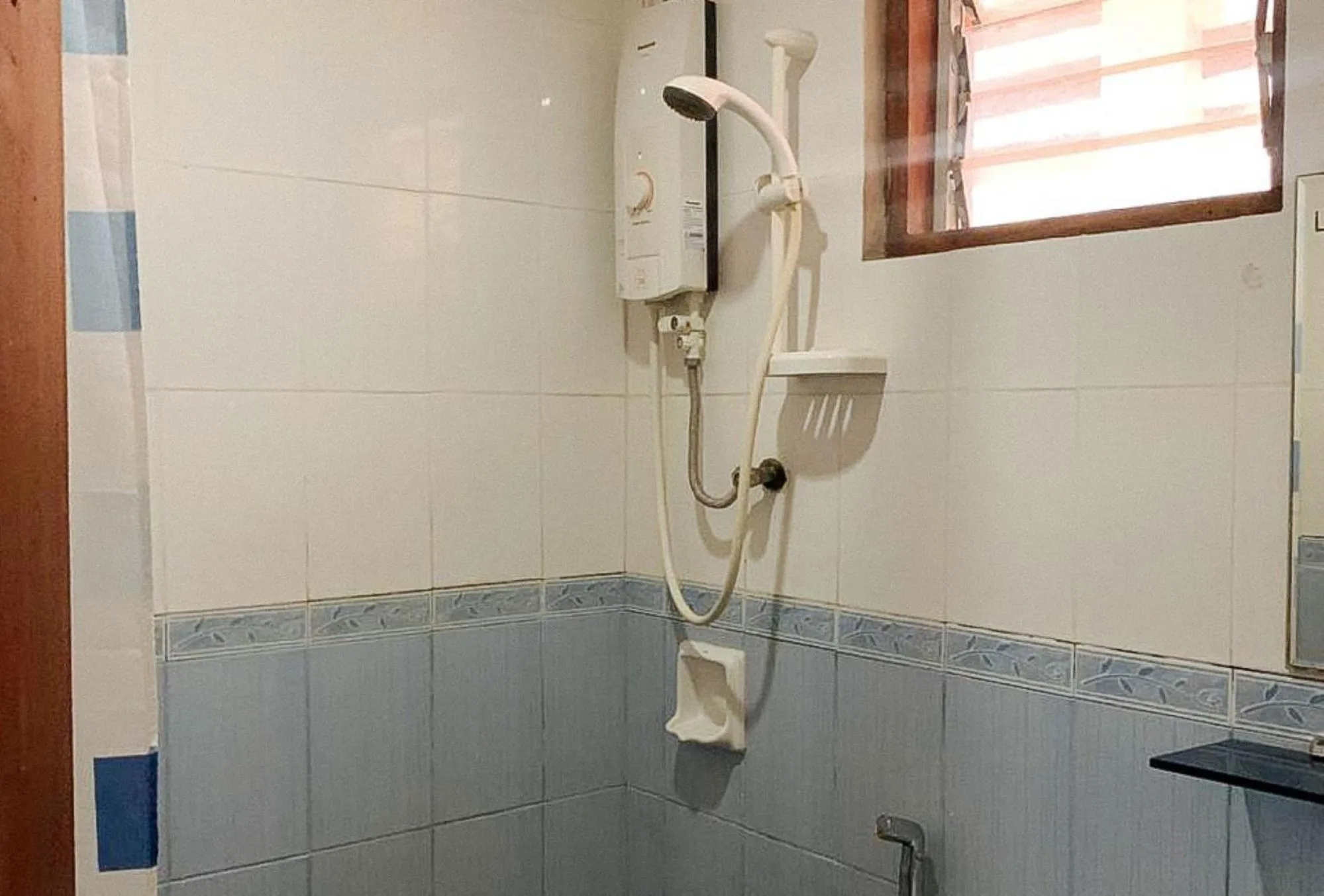 Shower in UrbanView BNKY Bed and Breakfast Palawan by RedDoorz