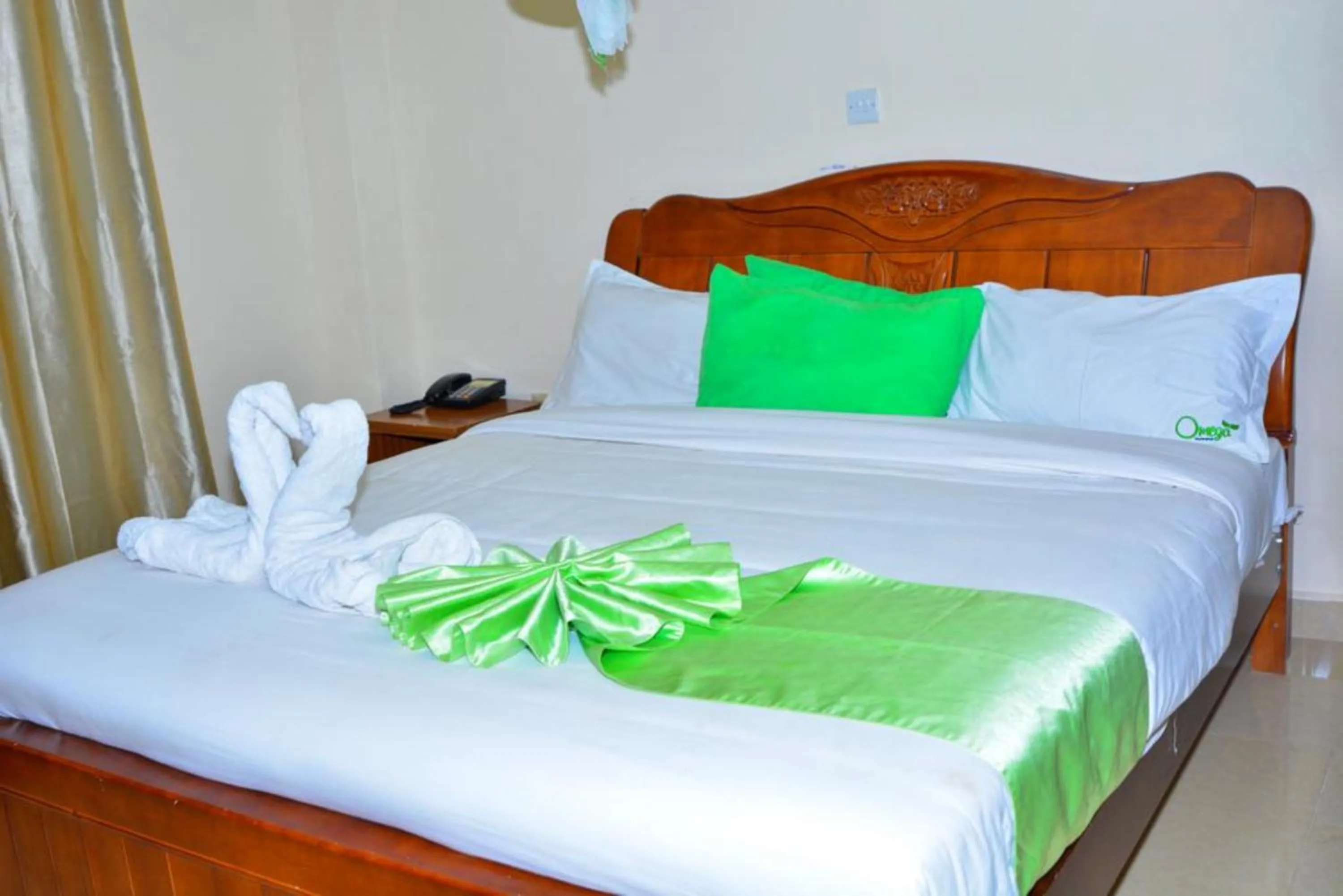 Bed in Omega Gardens Hotel