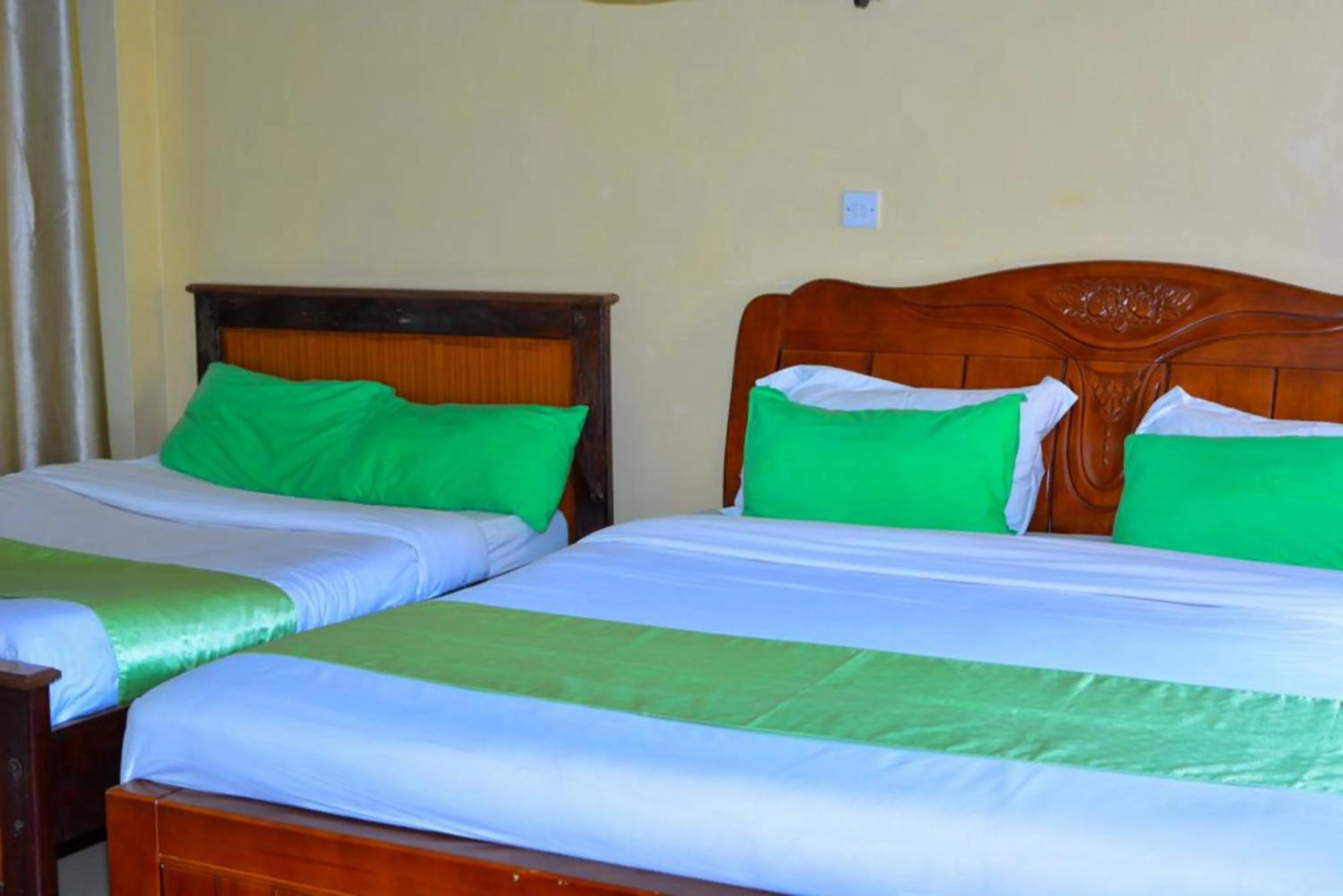 Bed in Omega Gardens Hotel