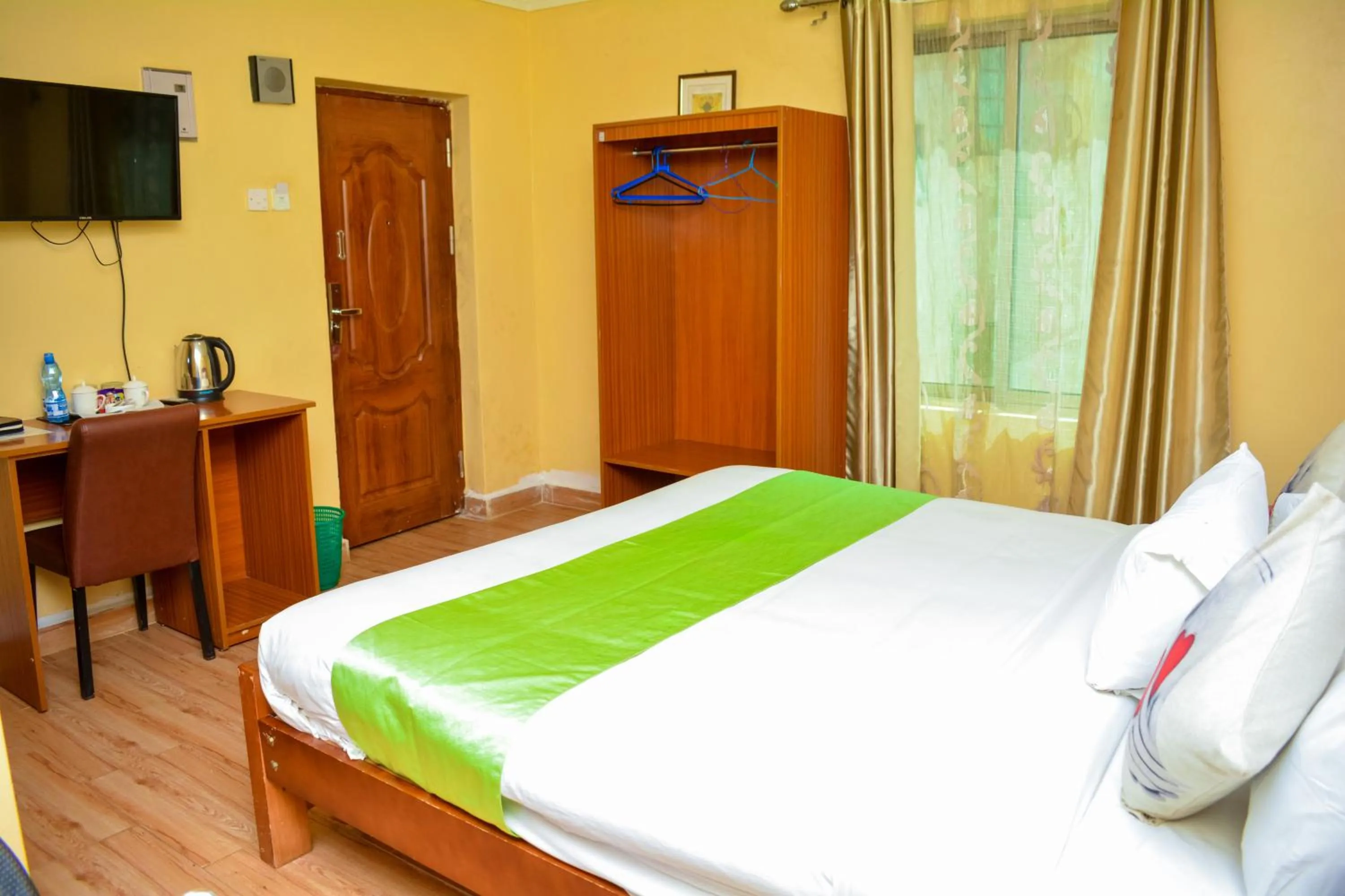 Bed in Omega Gardens Hotel