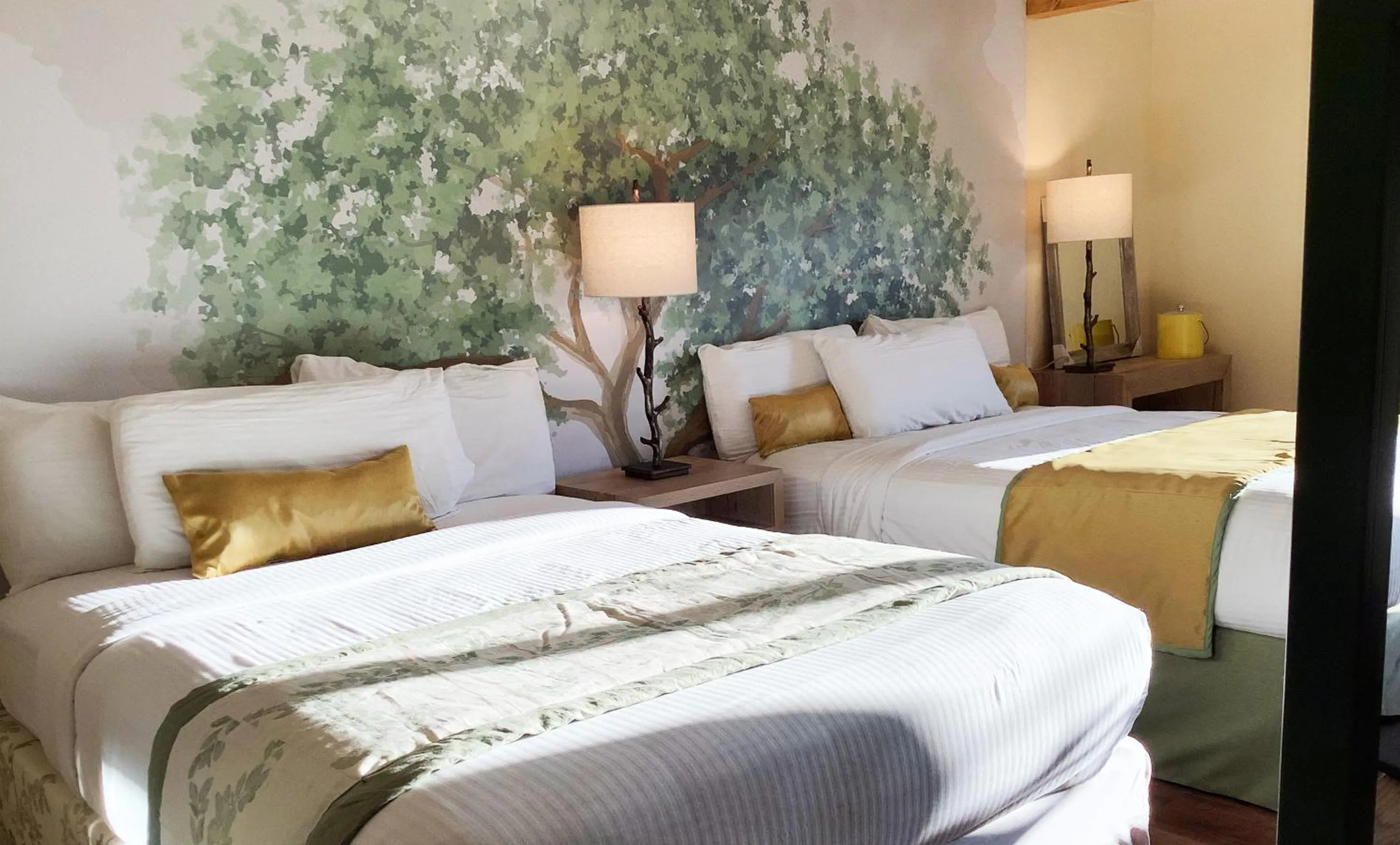 Bed in Arbors at Island Landing Hotel & Suites