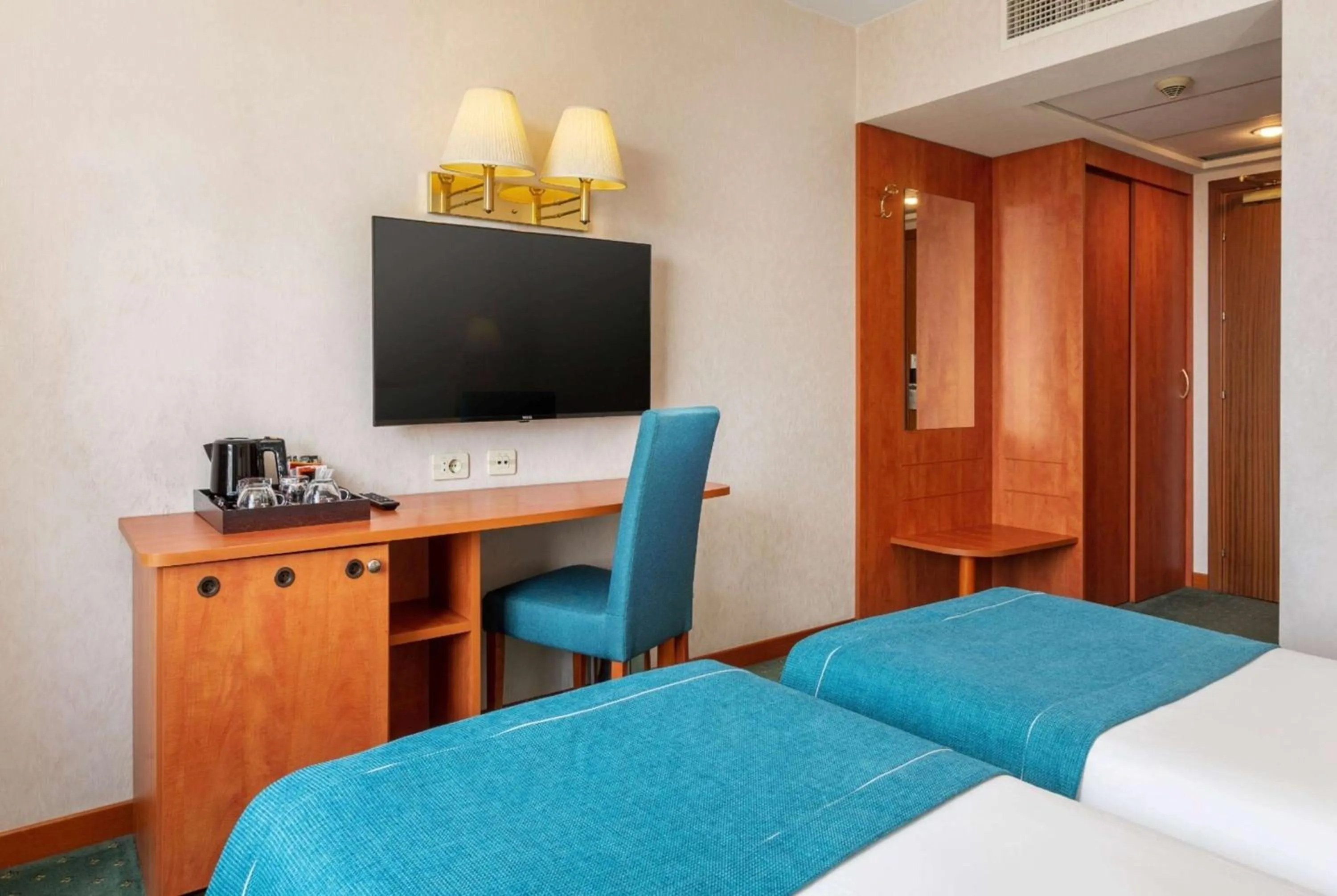 Bed in Ramada by Wyndham Bucharest Parc Hotel