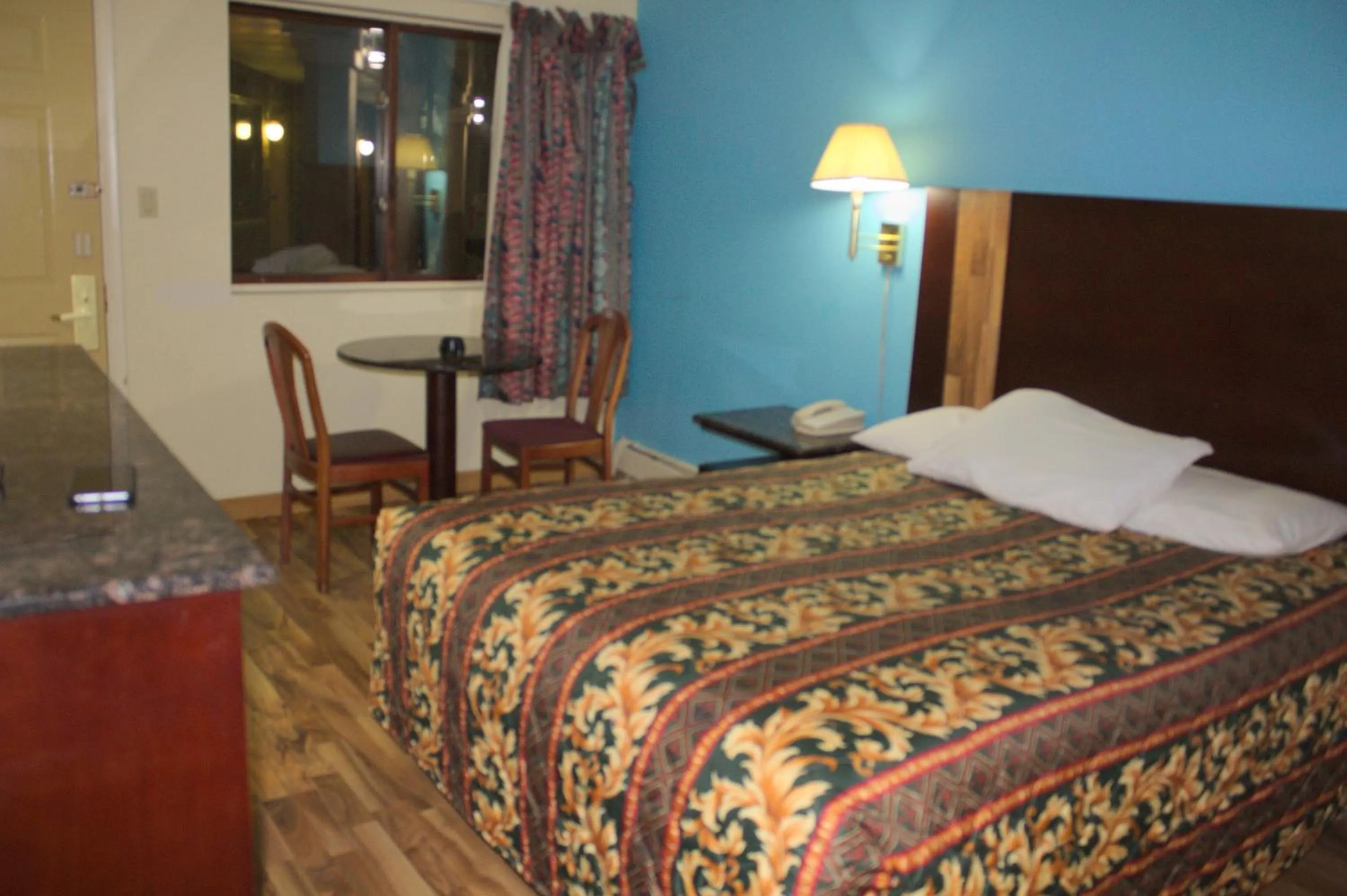 Bed in American Inn and Suites