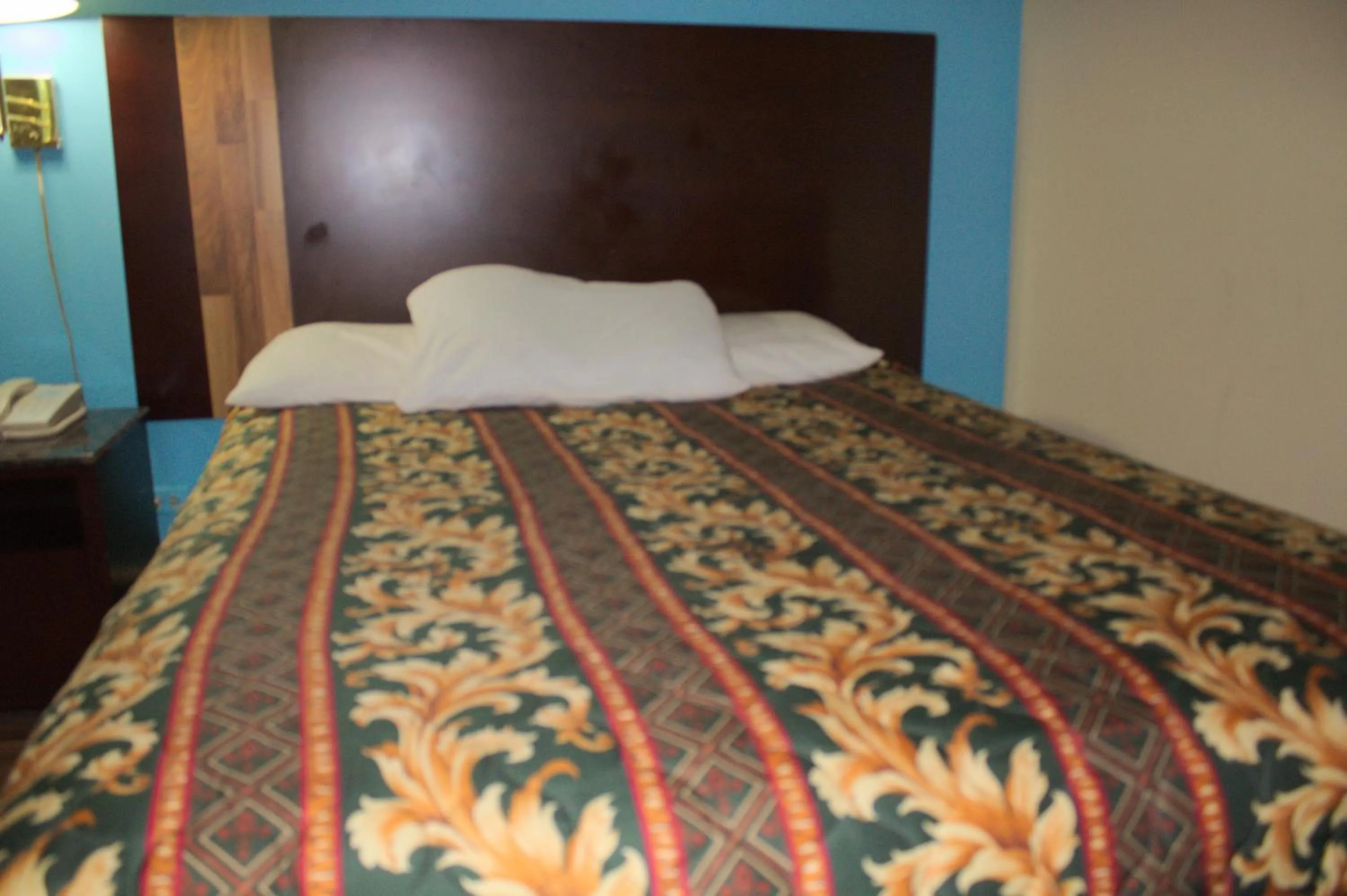 Bed in American Inn and Suites