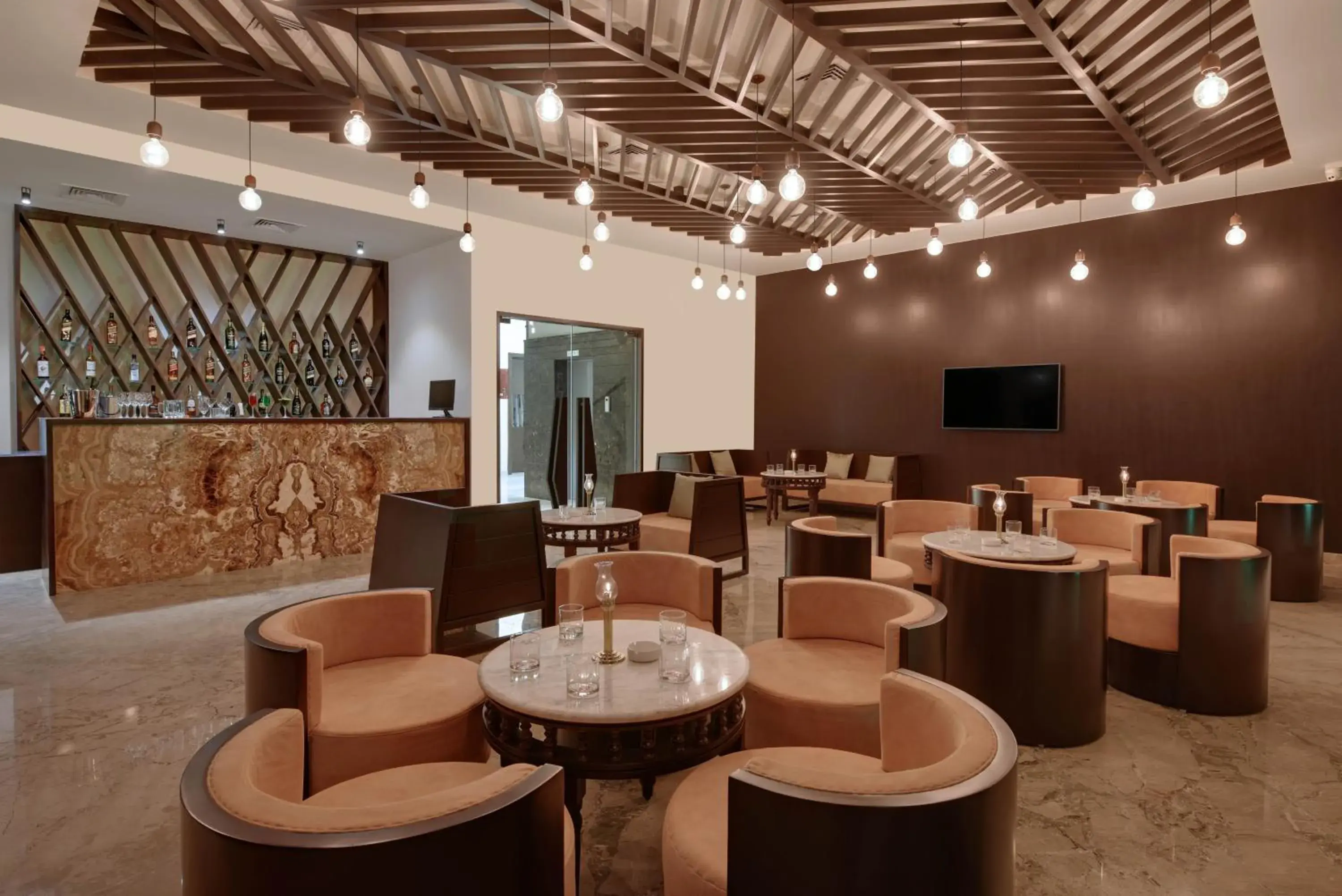 Lounge or bar in The Kumbha Residency by Trulyy - A Luxury Resort and Spa Lounge or bar in The Kumbha Residency by Trulyy - A Luxury Resort and Spa