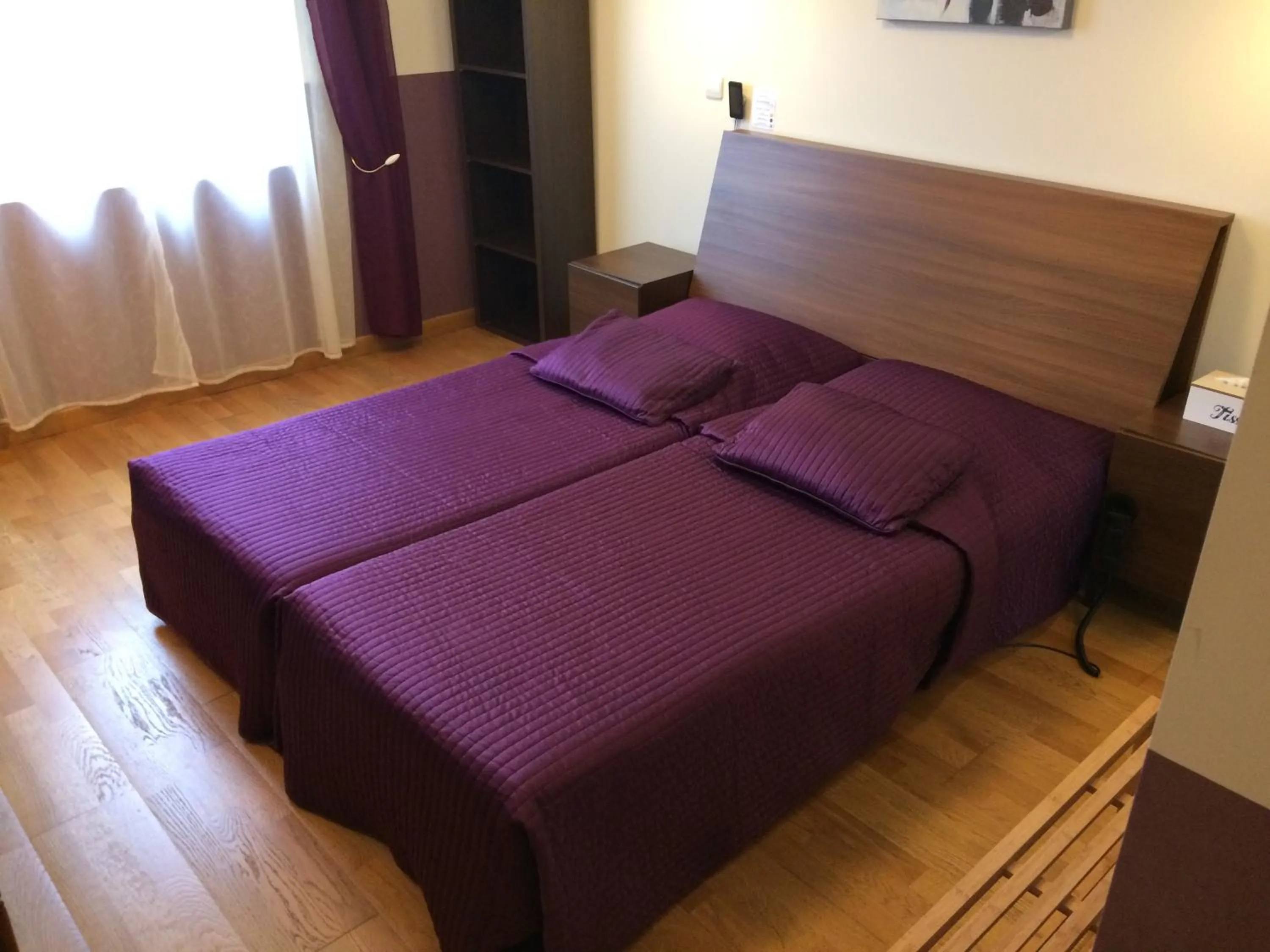 Bed in LOGIS Hôtel Le Chantoiseau