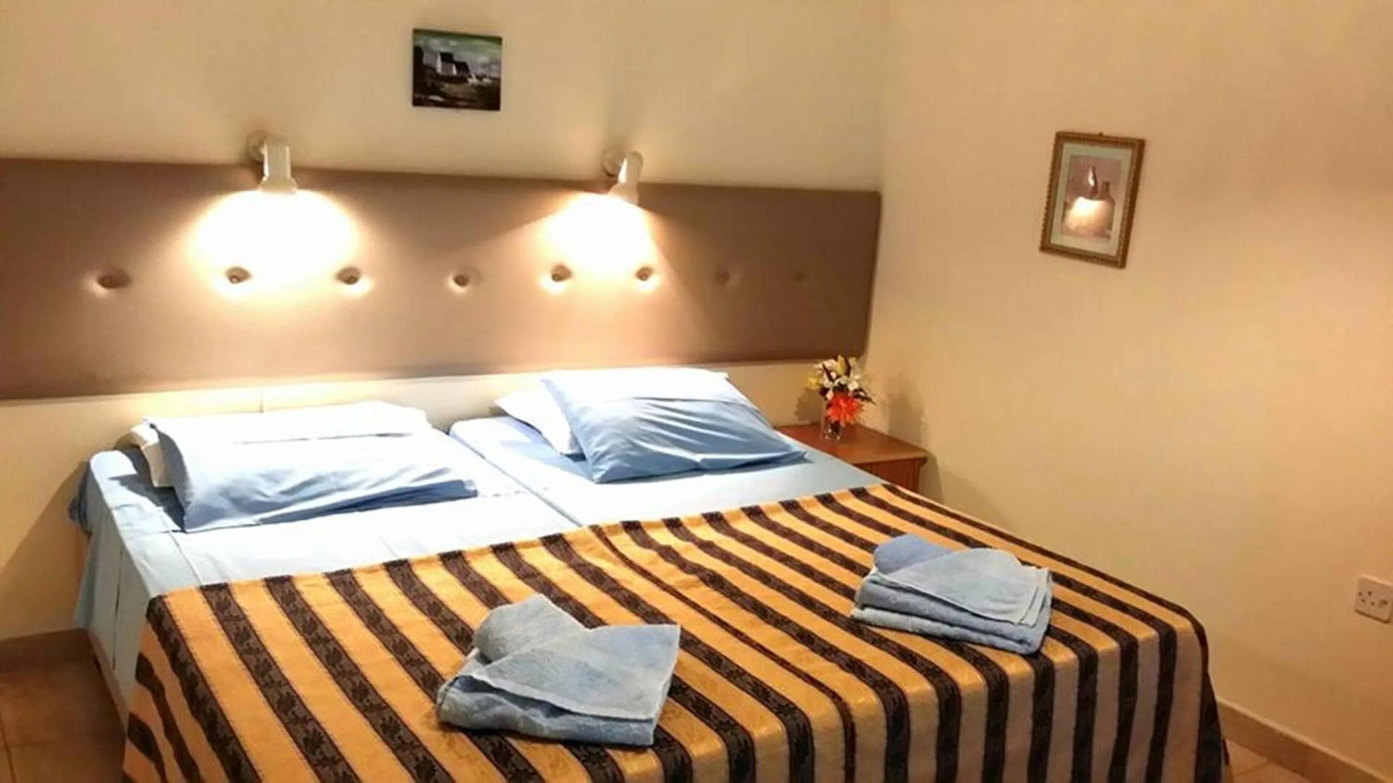 Bed in Florence Hotel Apartments