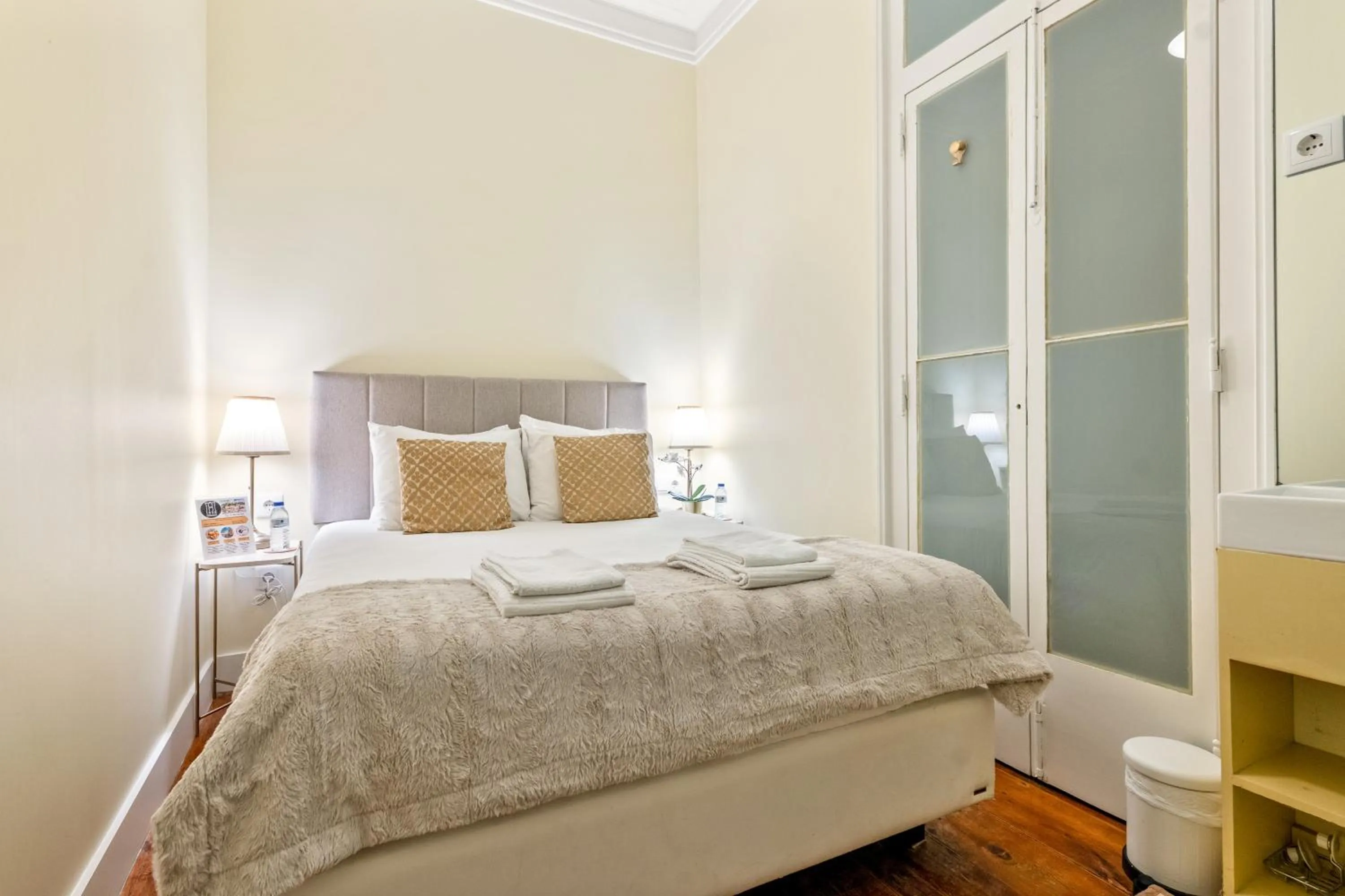 Bed in 1898 Home & Suites