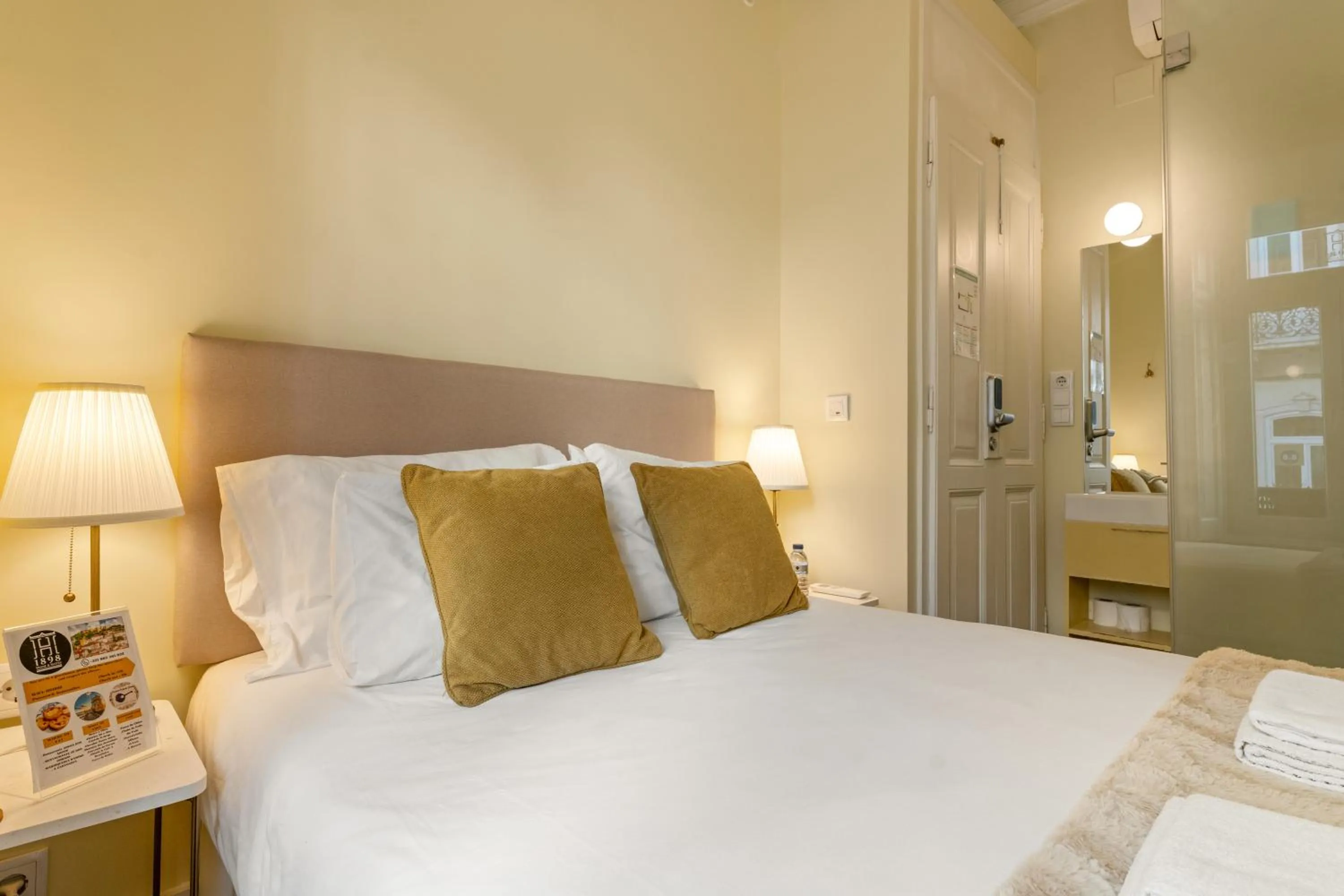 Bed in 1898 Home & Suites