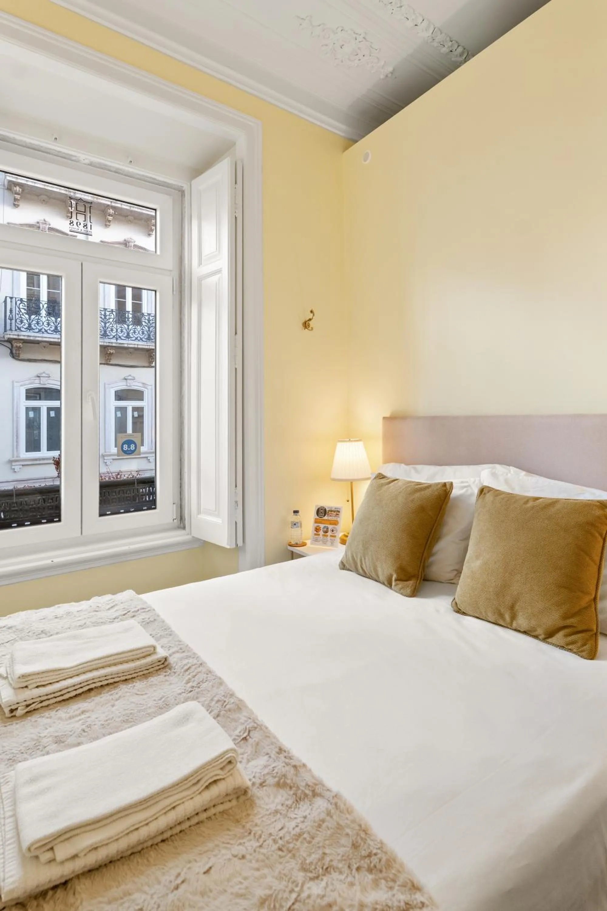 Bed in 1898 Home & Suites