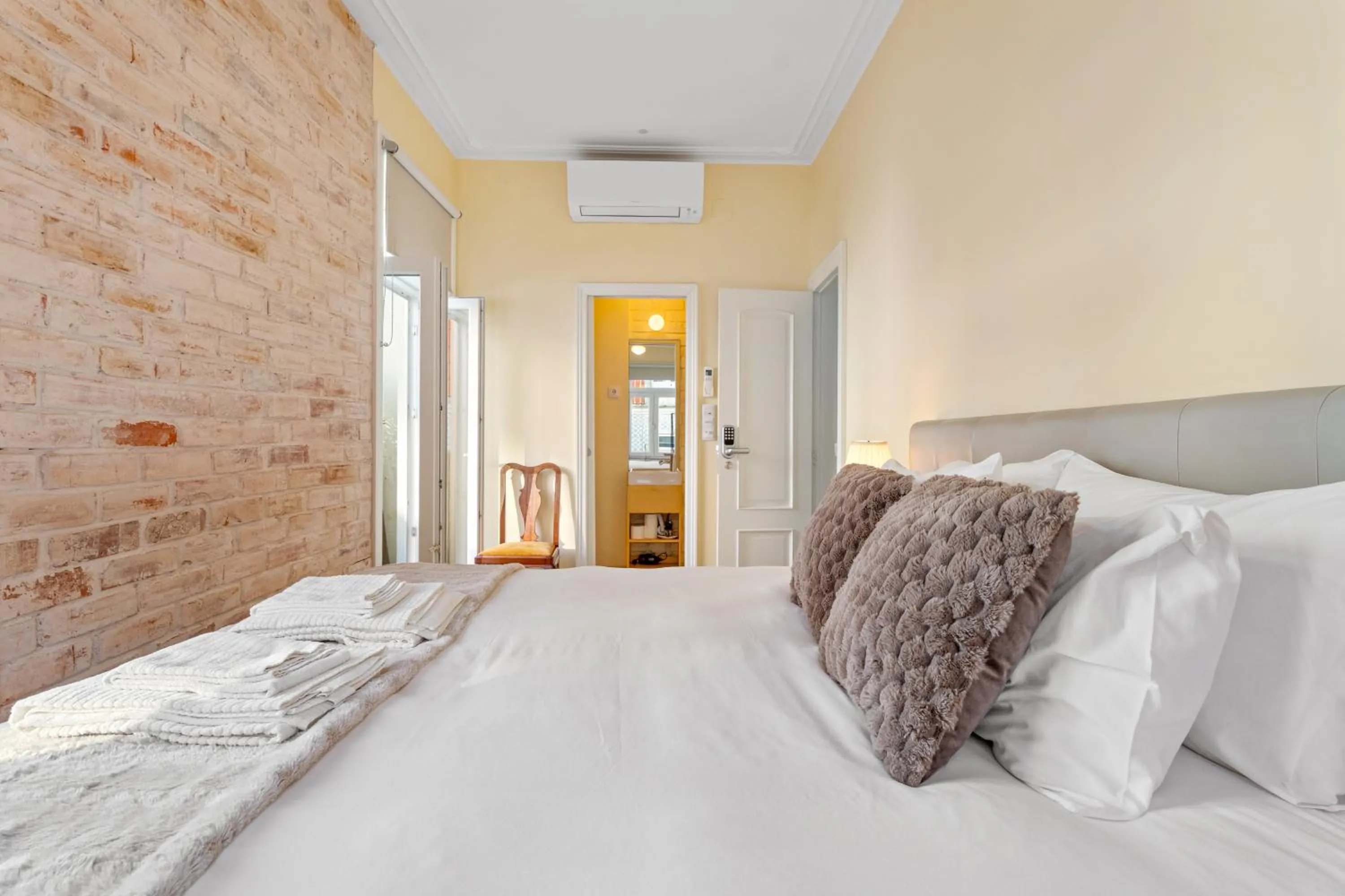 Bed in 1898 Home & Suites