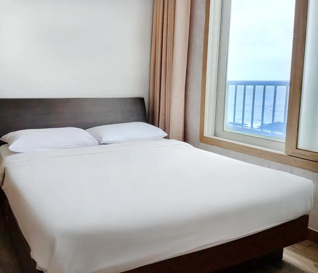 Bed in Jeju Ilsung Beach Condo