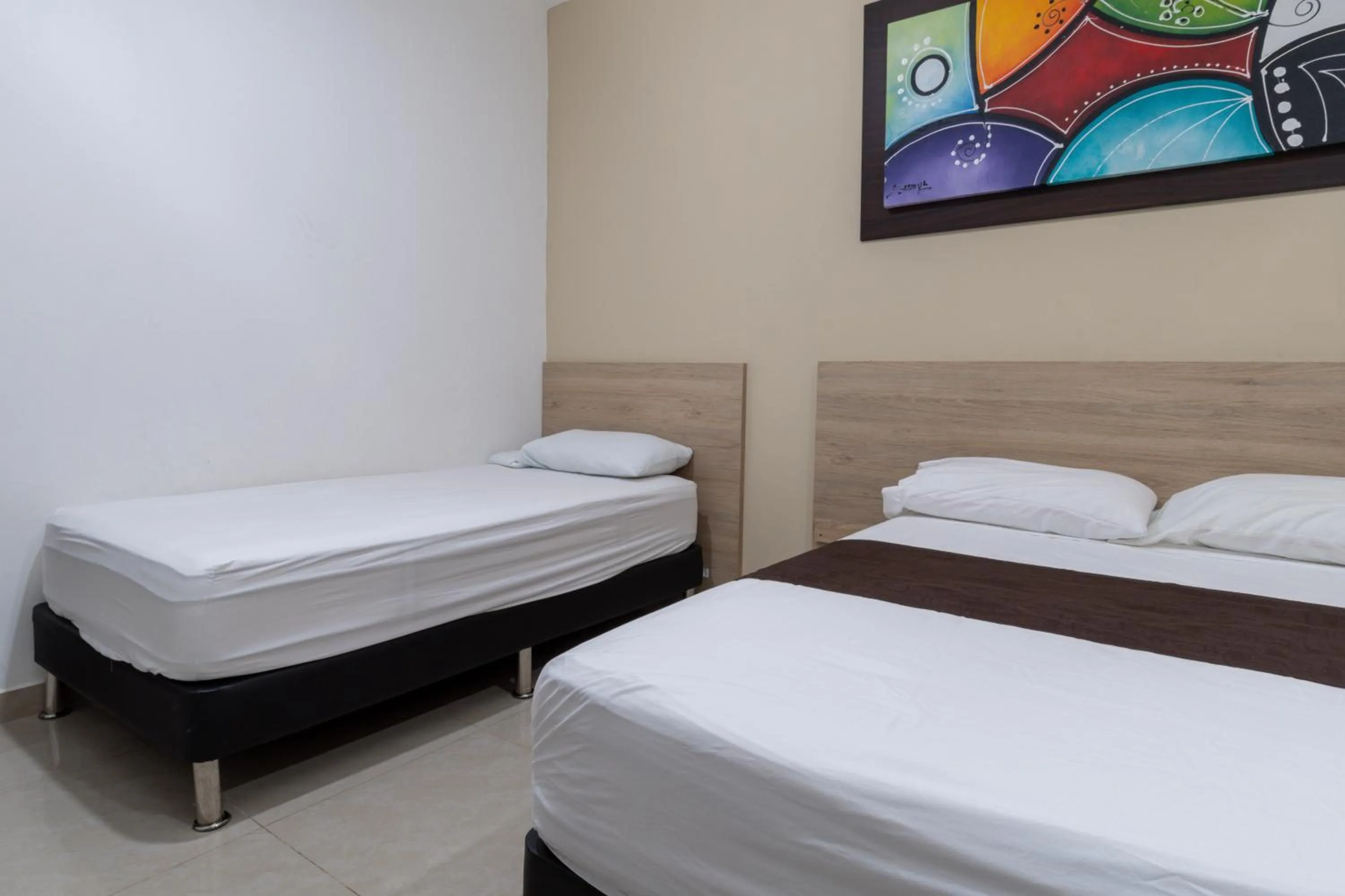 Bed in Genesis Hotel