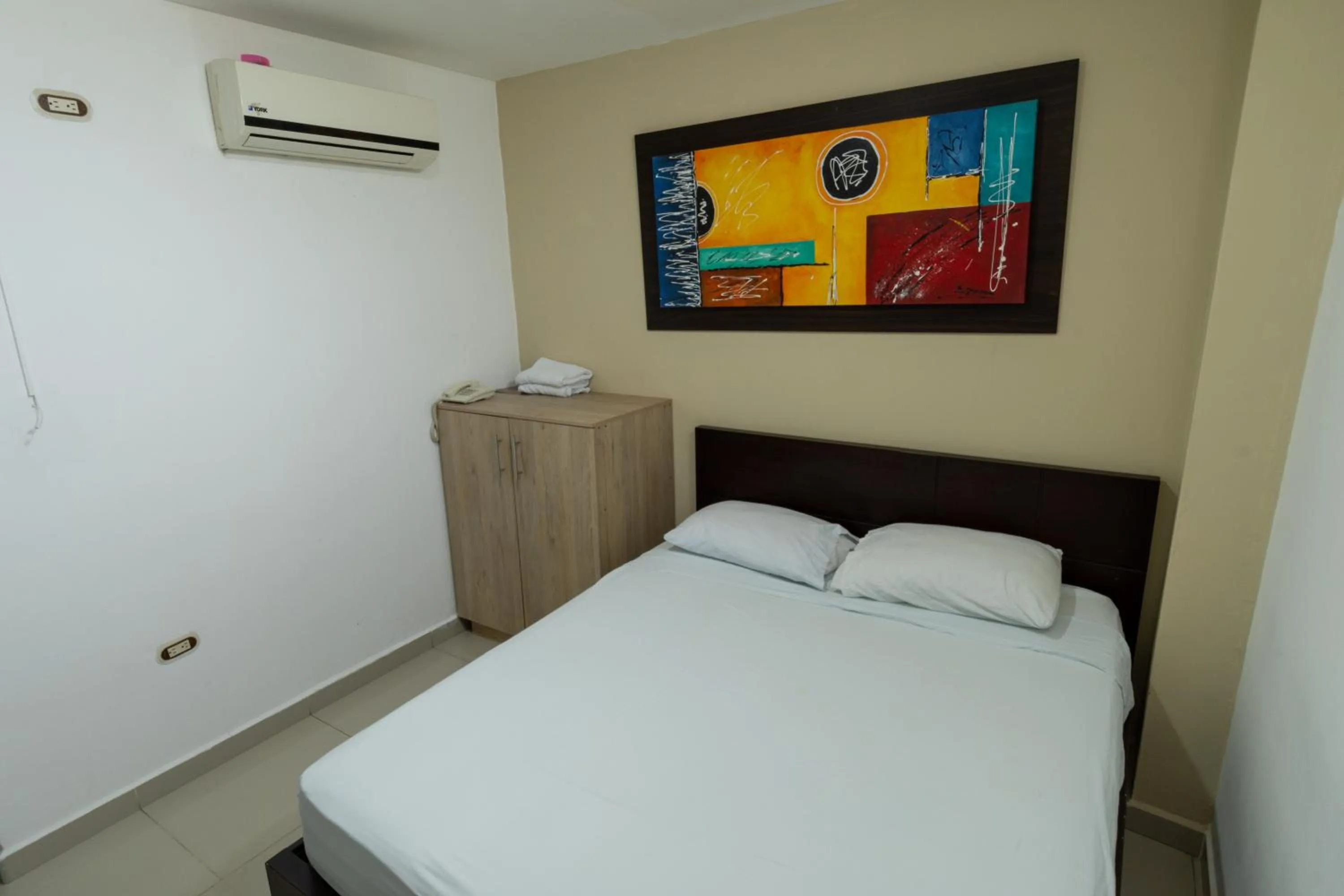 Bed in Genesis Hotel