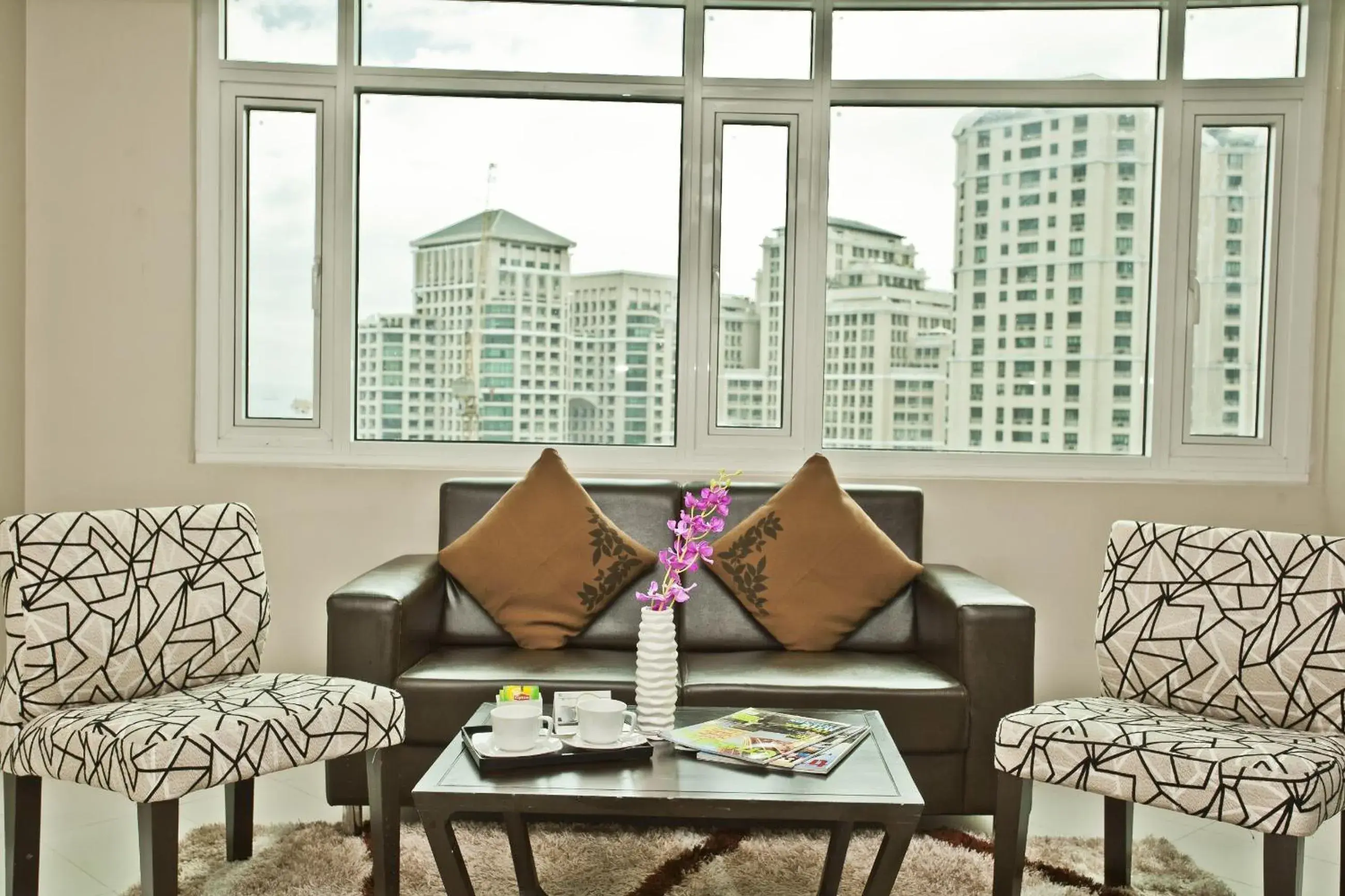 Living room in The Exchange Regency Residence Hotel Managed by HII Living room in The Exchange Regency Residence Hotel Managed by HII