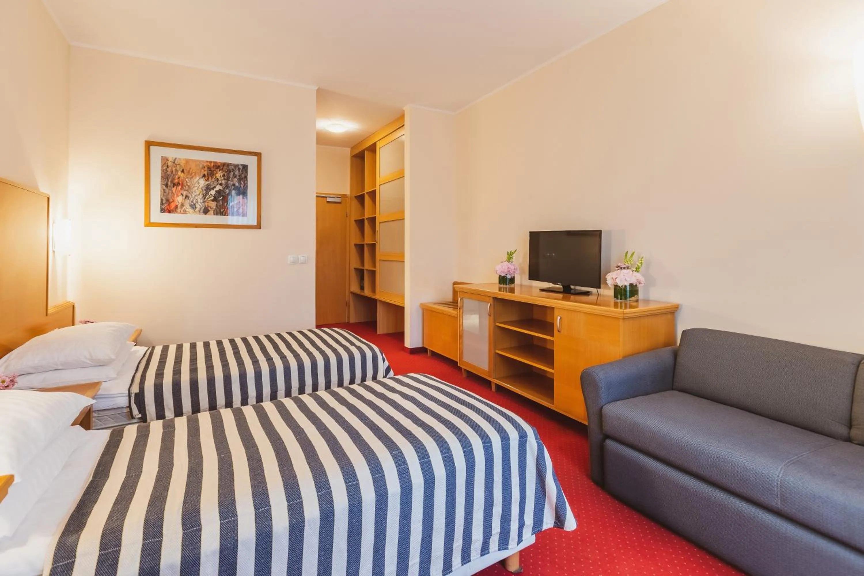 Communal lounge/ TV room, Bed in Ramada Hotel & Suites Kranjska Gora