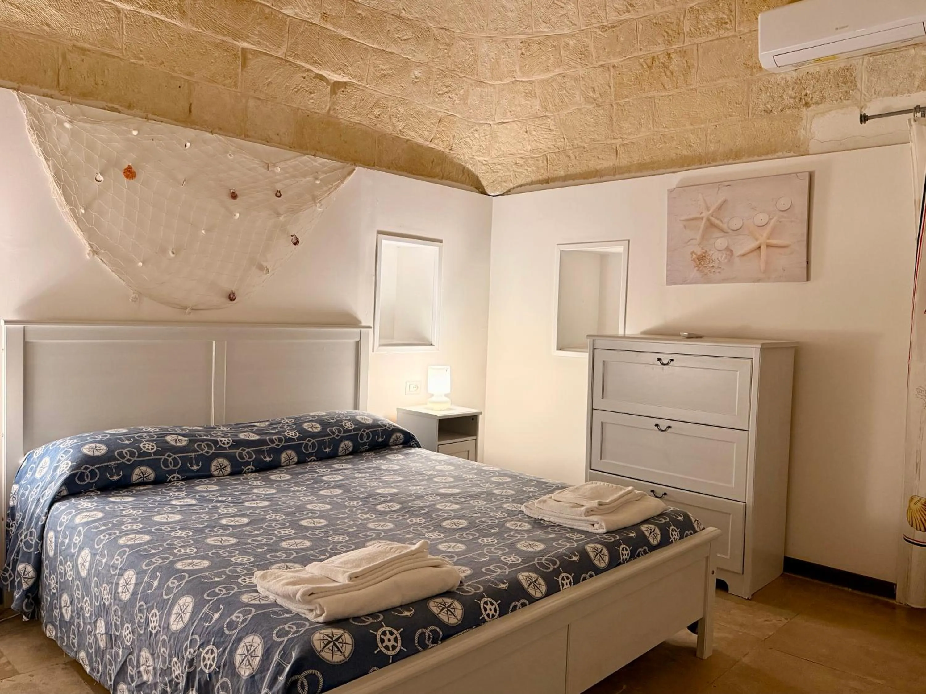 Bed in Baia Sangiorgio Hotel & Beach Club