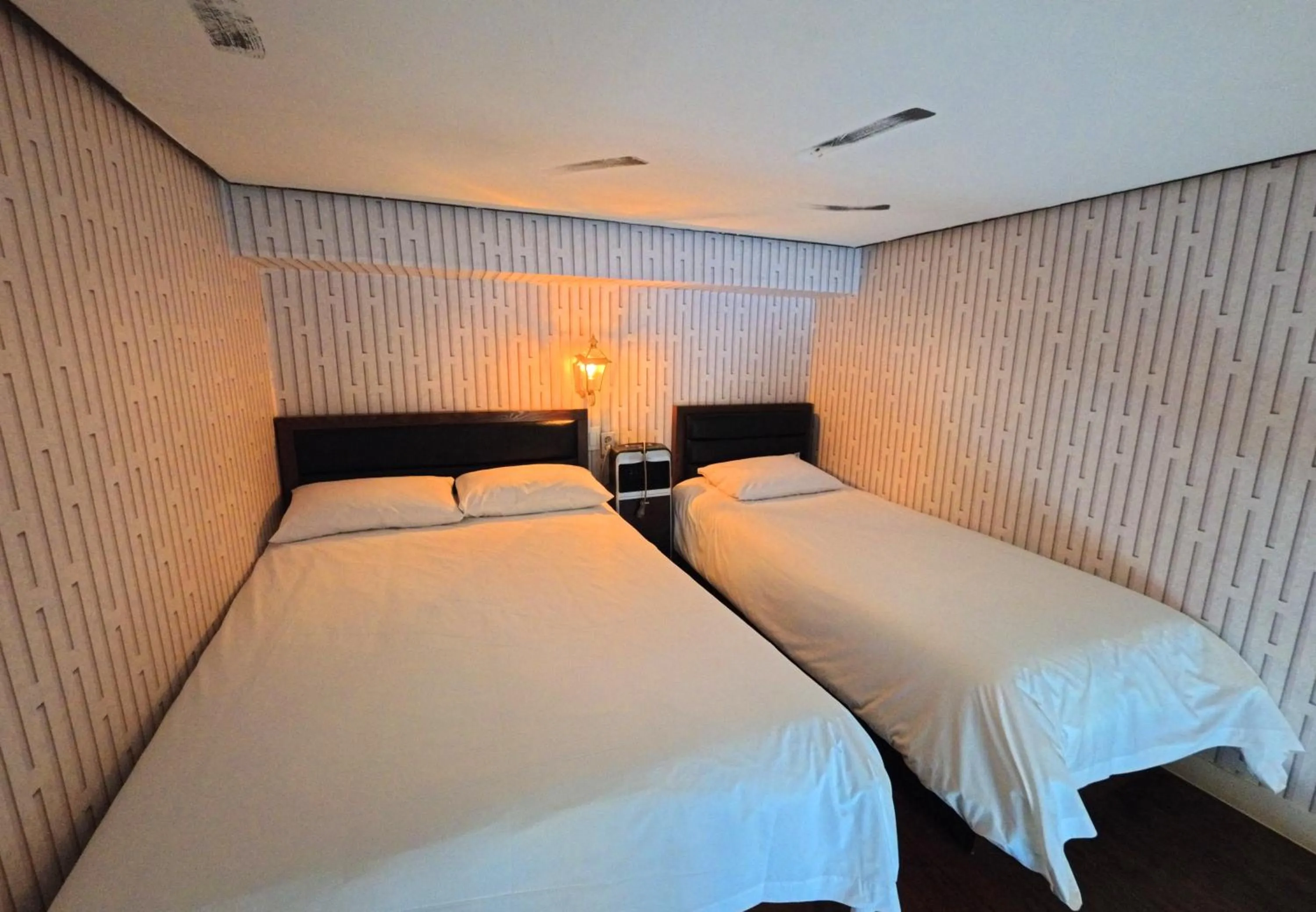 Bed in Friendly DH Naissance Hotel by Mindrum Group