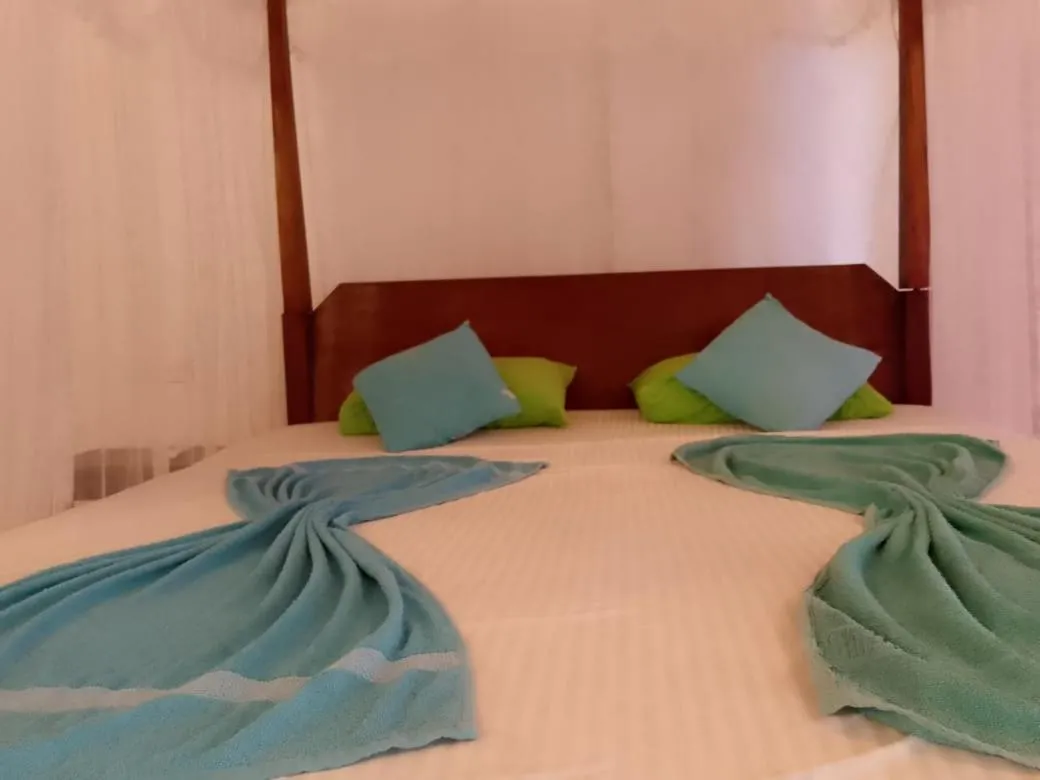 Bed in Sunset Colony Beach Resort
