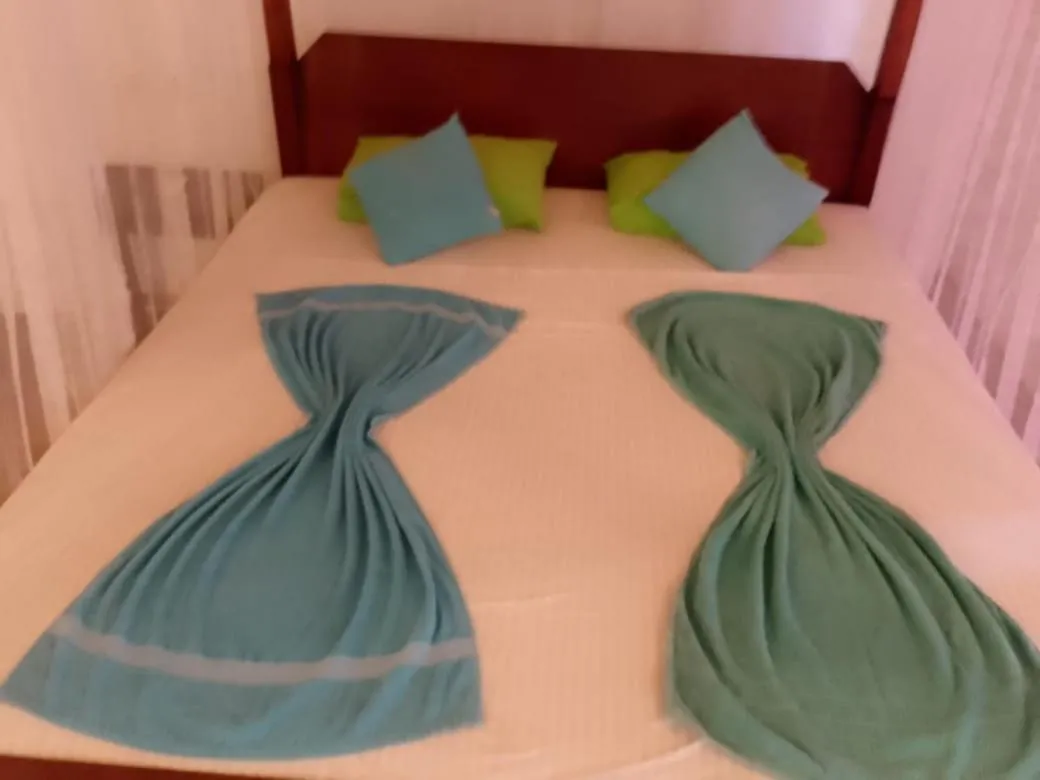 Bed in Sunset Colony Beach Resort