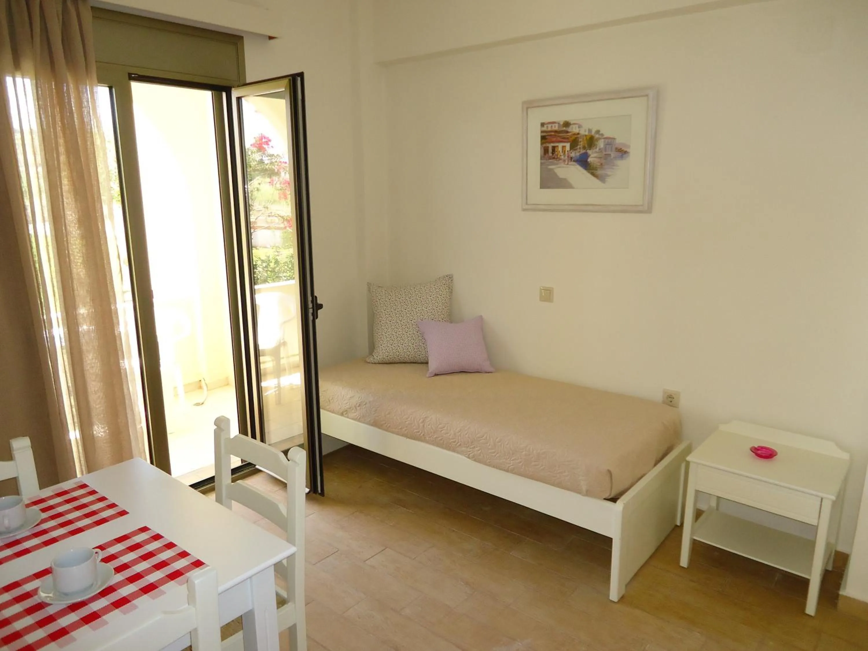 Bed in Almyra Apartments & Suites