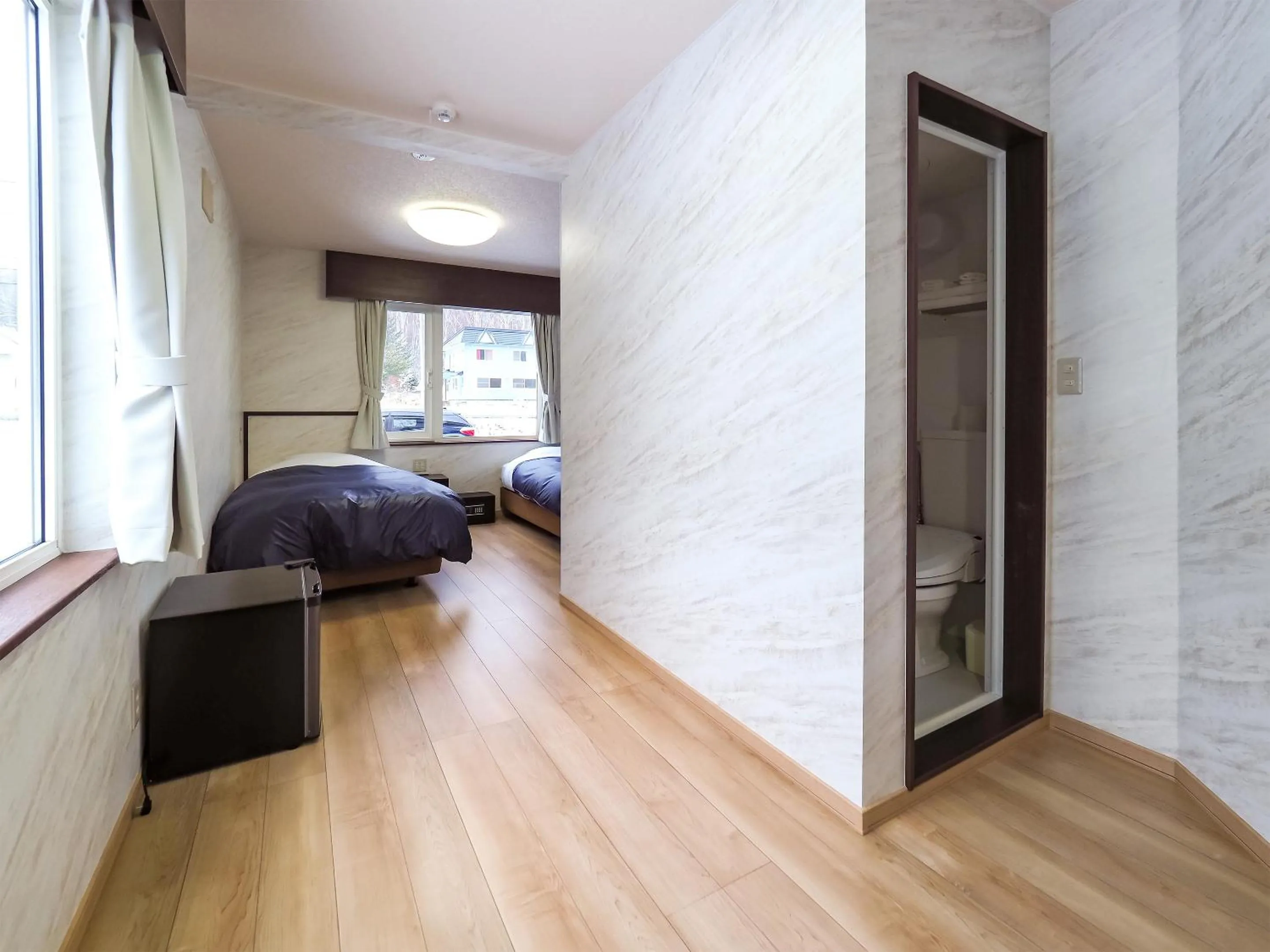 Living room, Bed in Petit Hotel Gracey Tomamu