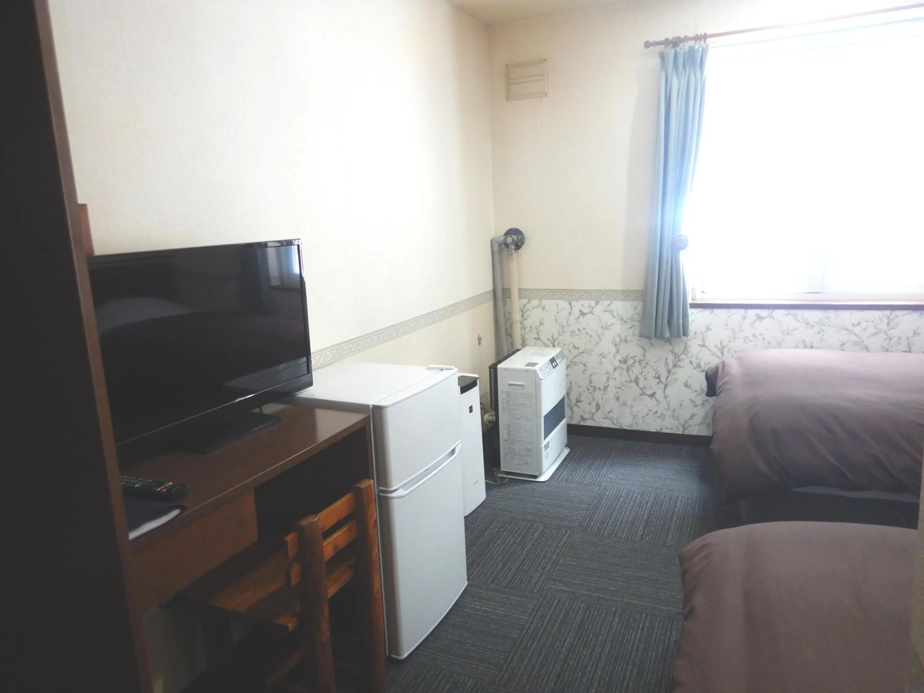 Bed in Petit Hotel Gracey Tomamu