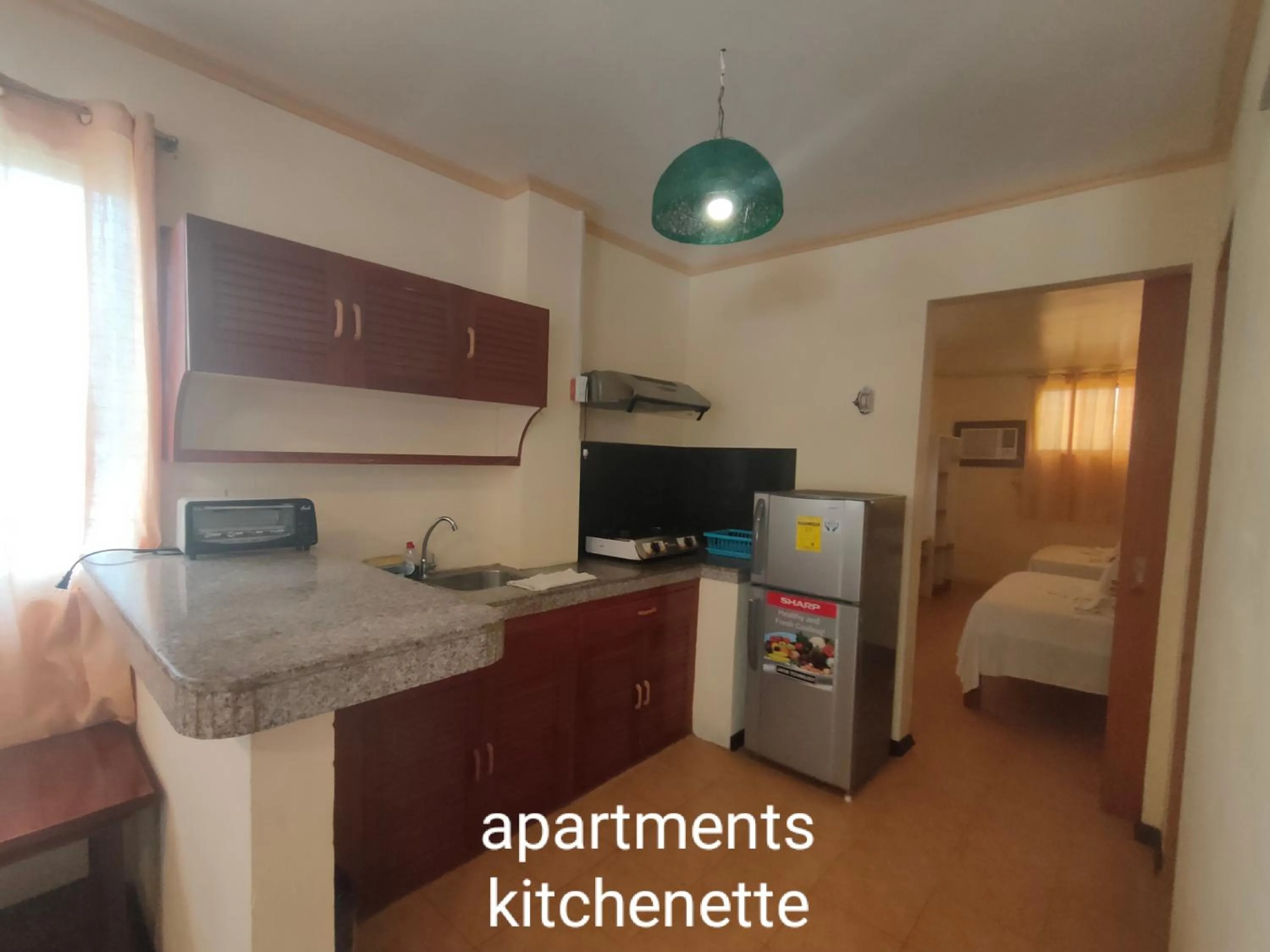 Kitchen or kitchenette, Bed in Sulu Plaza