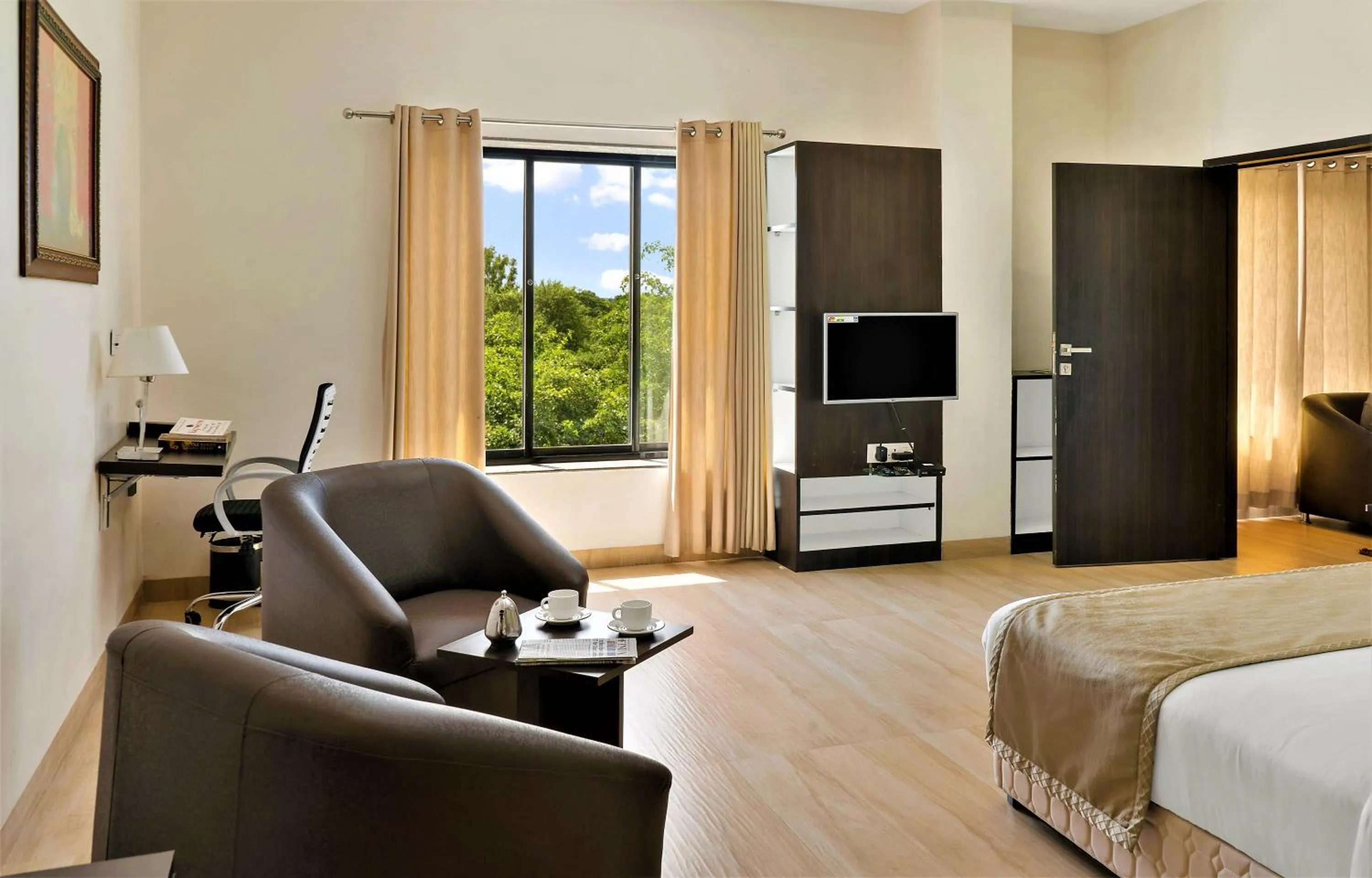 Seating area, Bed in The Fern Residency Parbhani